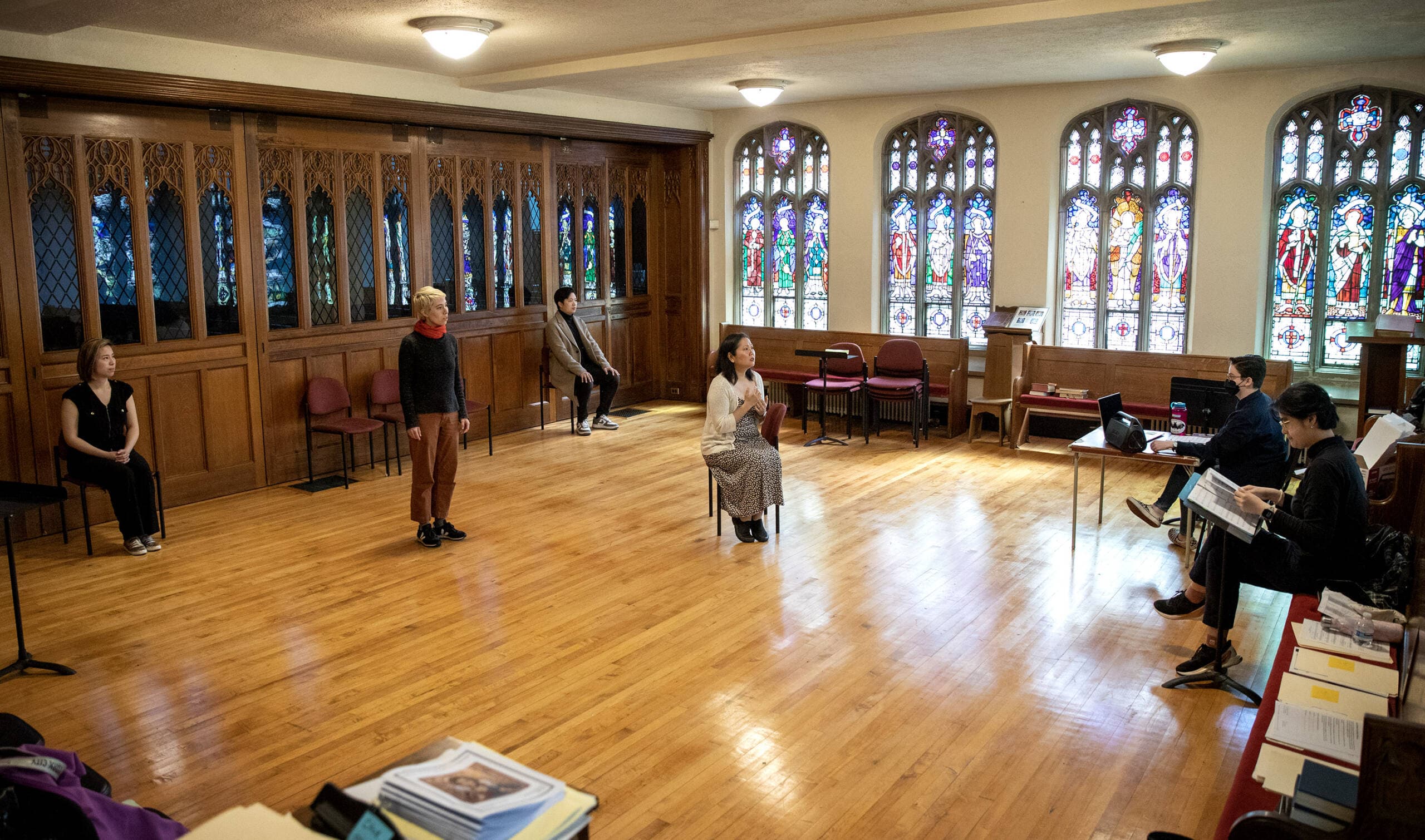 The cast of Guerilla Opera's production of "HER | alive.un.dead" rehearse at Trinity Parish in Newton. (Robin Lubbock/WBUR)