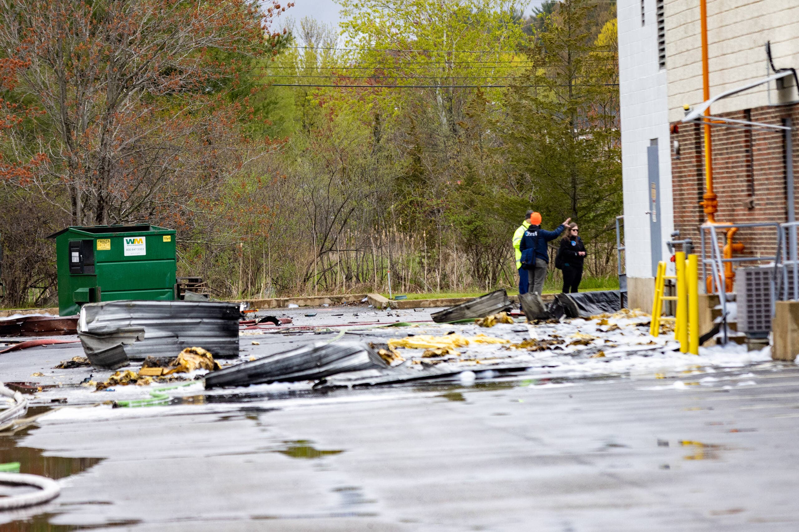 OSHA officials examine the debris scattered around the Seqens/PCI Synthesis plant after a chemical explosion. (Jesse Costa/WBUR)