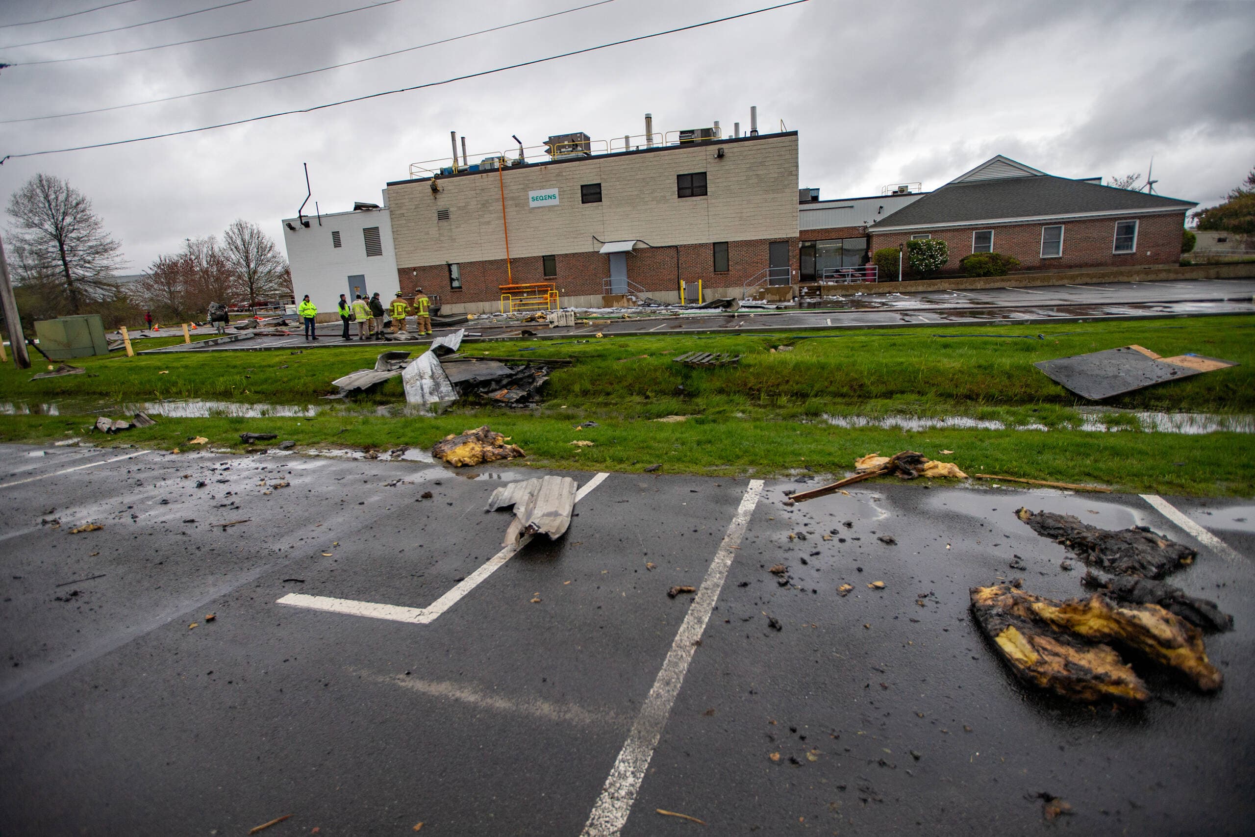 Newburyport firefighters examine the debris on Thursday. (Jesse Costa/WBUR)