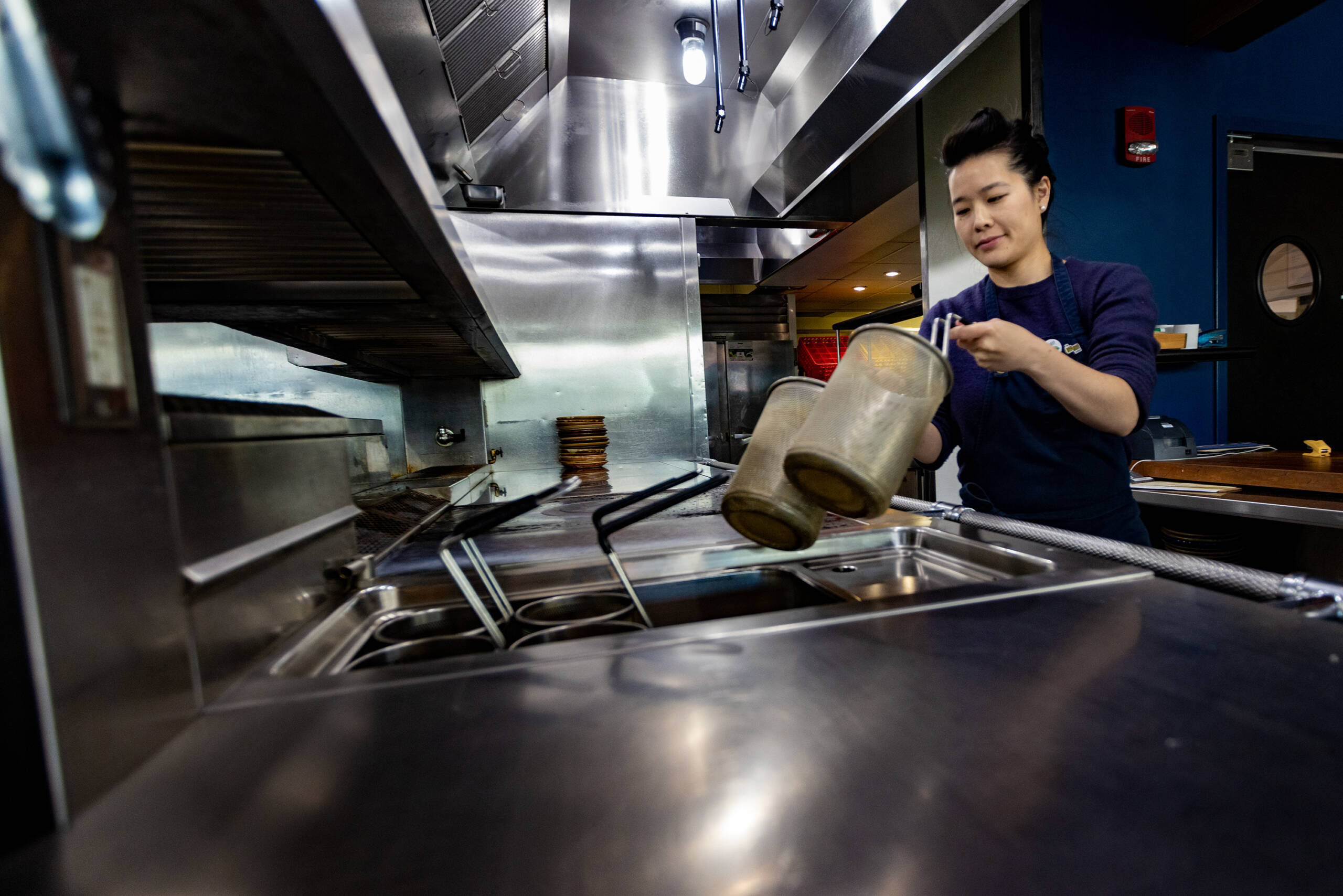 Pagu owner Tracy Chang sets up the fryolator preparing for a dinner event later that evening. (Jesse Costa/WBUR)