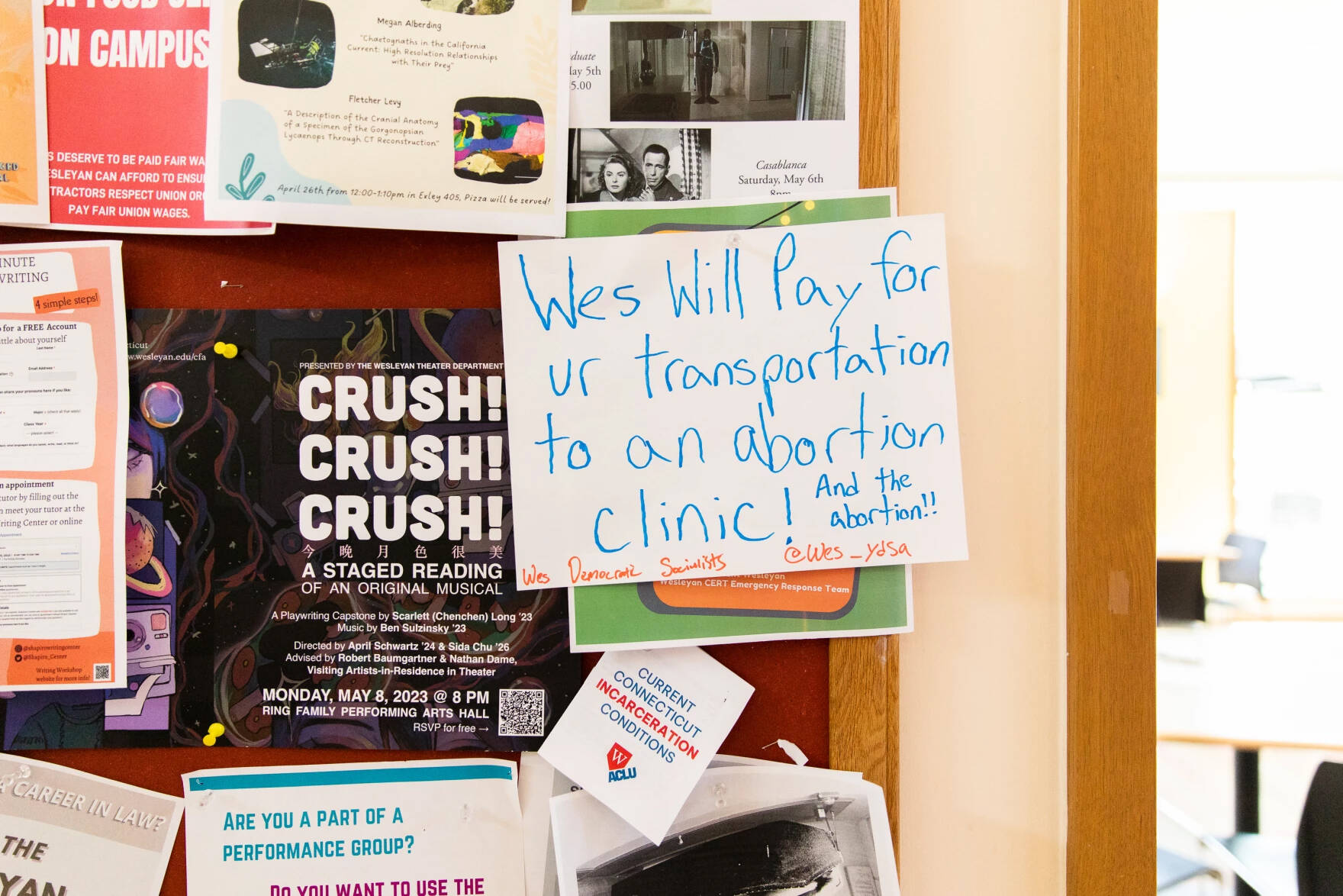 A sign posted inside the Usdan University Center informs the student body that the University agreed to meet their demands to cover healthcare costs related to abortion. (Greg Miller/Connecticut Public)