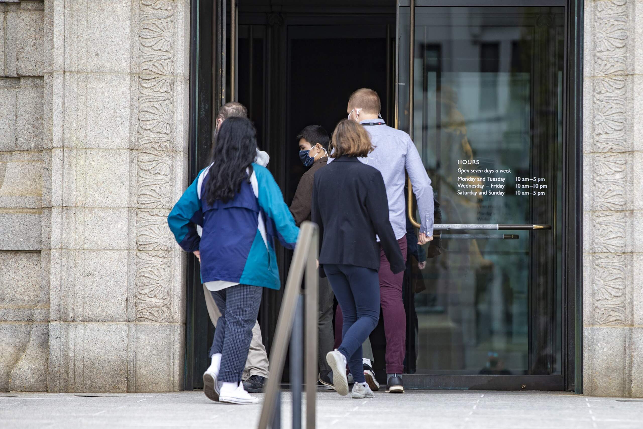 Employees of the Museum of Fine Arts enter the museum. (Jesse Costa/WBUR)
