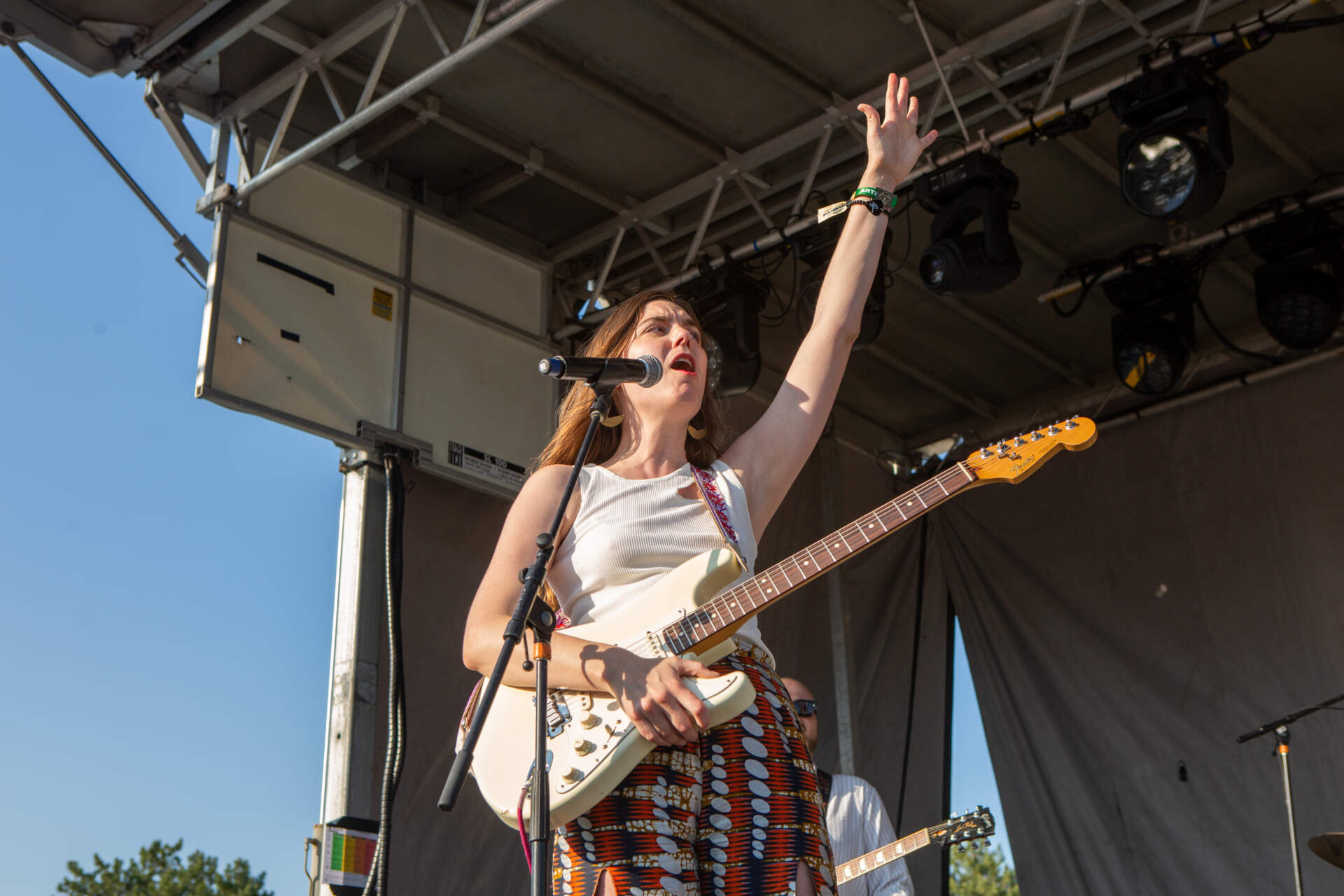 Vermont-based artist Ali McGuirk sings on the Orange Stage at Boston Calling. (Jacob Garcia/WBUR)