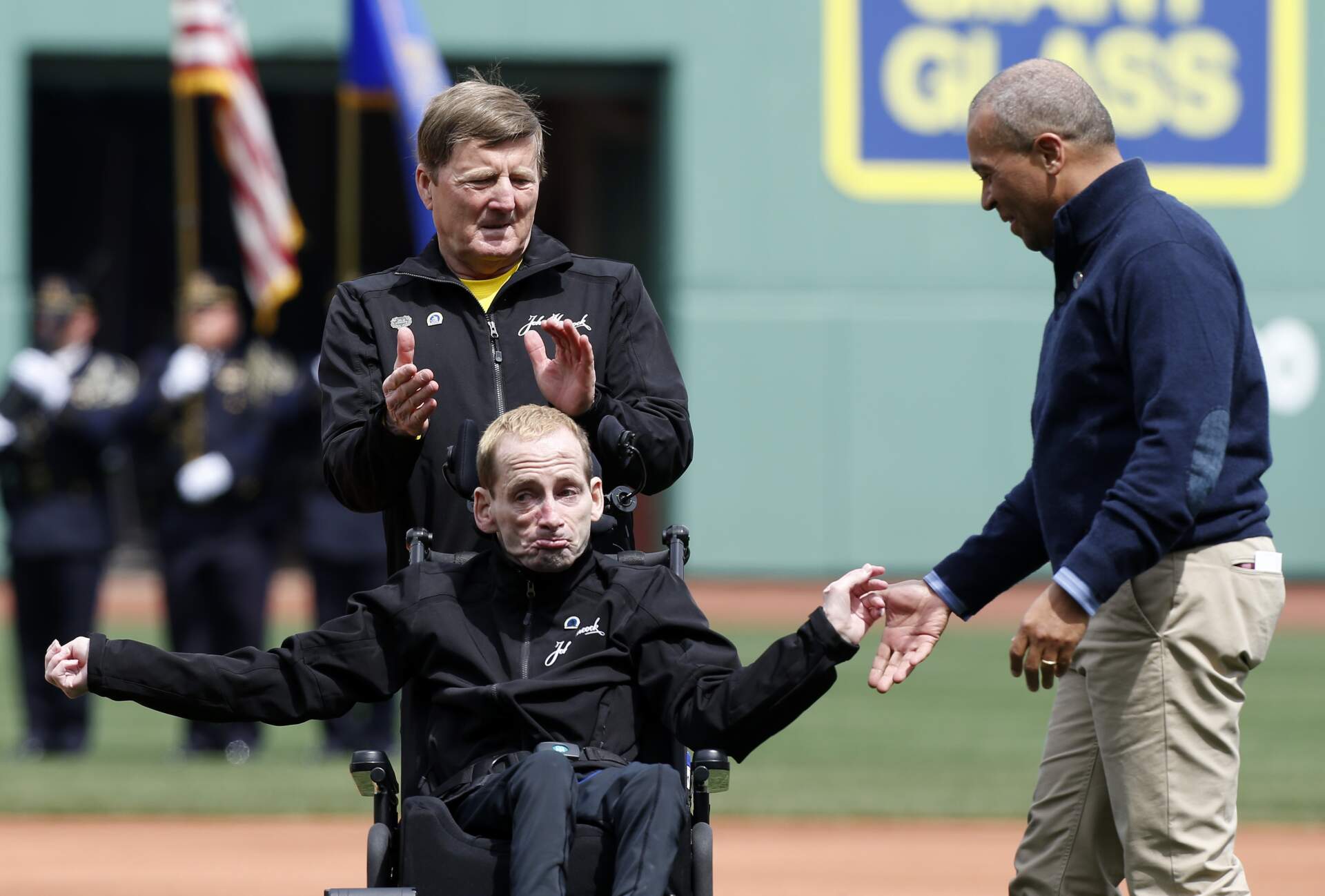 Massachusetts Gov. Deval Patrick, right, greets marathoners Rick Hoyt and his father Dick before the ceremonial first pitch in a baseball game between the Boston Red Sox and the Kansas City Royals at Fenway Park in 2013. (Michael Dwyer/AP)