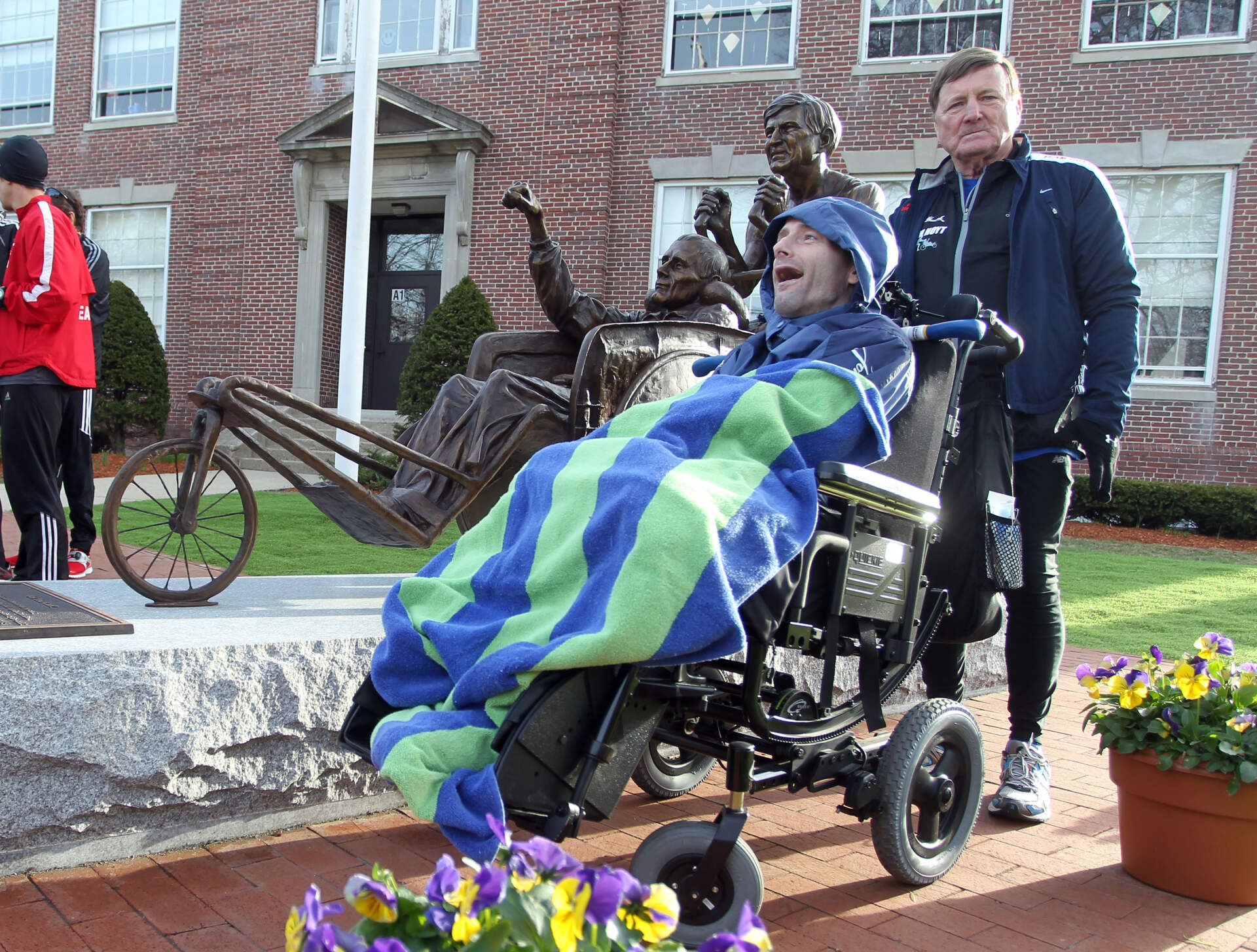Dick Hoyt, right, and his son, Rick, stand next to a statue honoring them near the start of the 117th running of the Boston Marathon, in Hopkinton in 2013. (Stew Milne/AP)