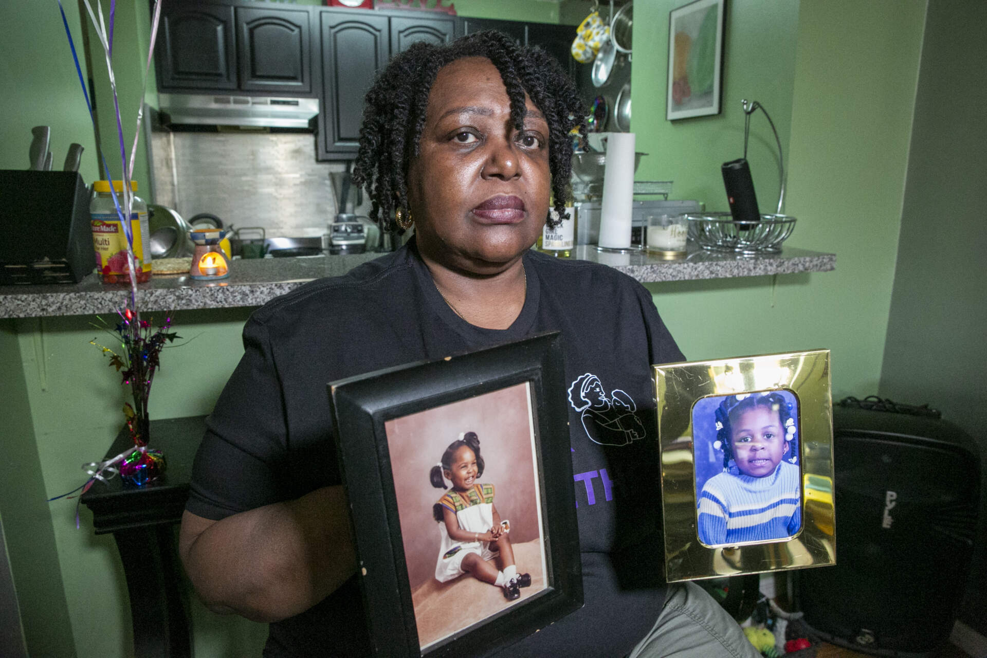 Joyce McMillan shows pictures of her children at her home in the Harlem neighborhood of New York City on Monday, May 15, 2023. (Ted Shaffrey/AP)