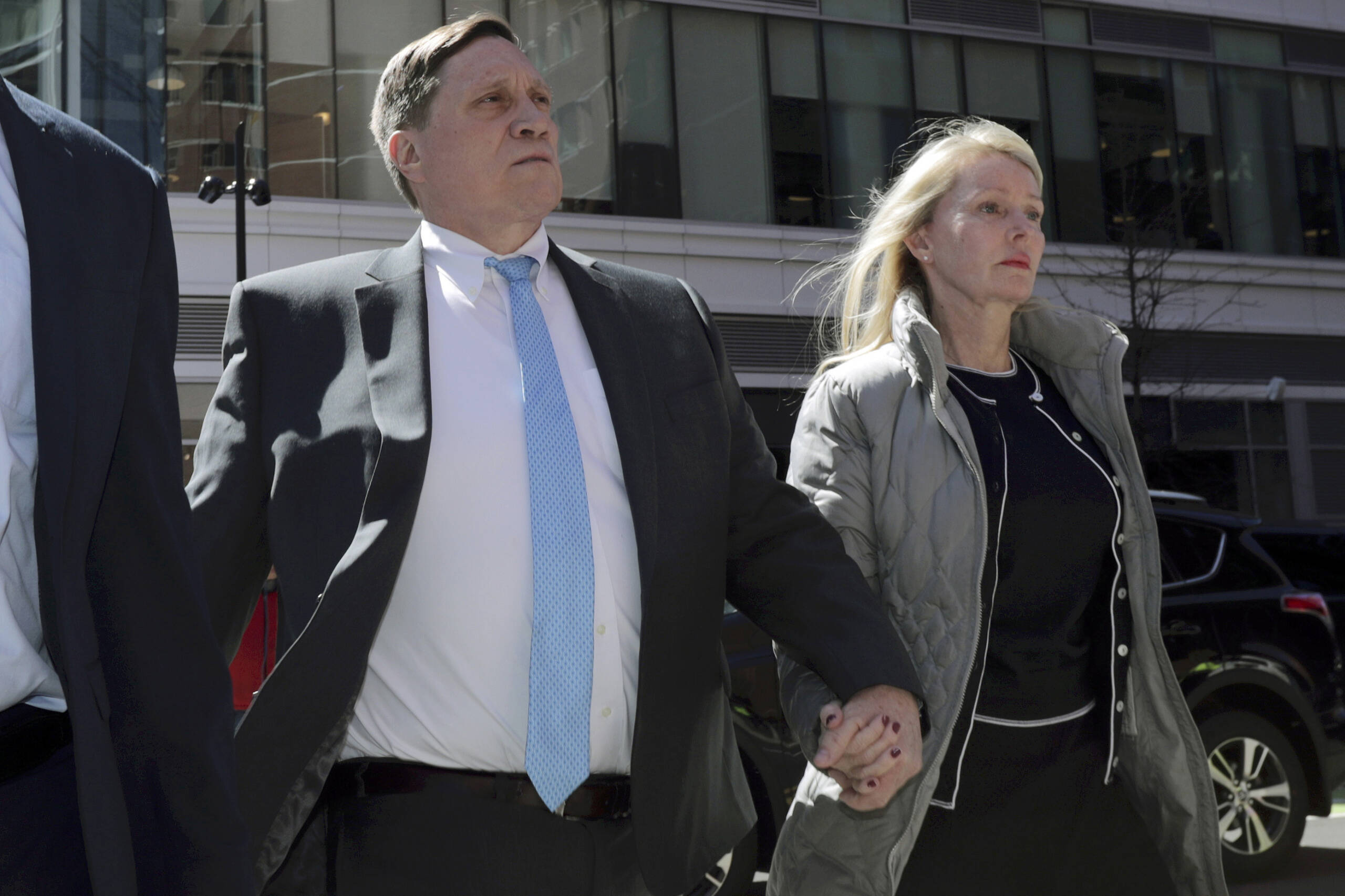 John Wilson, of Lynn, arrives at federal court with his wife Leslie, April 3, 2019, to face charges in a nationwide college admissions bribery scandal, in Boston. (Charles Krupa/AP)