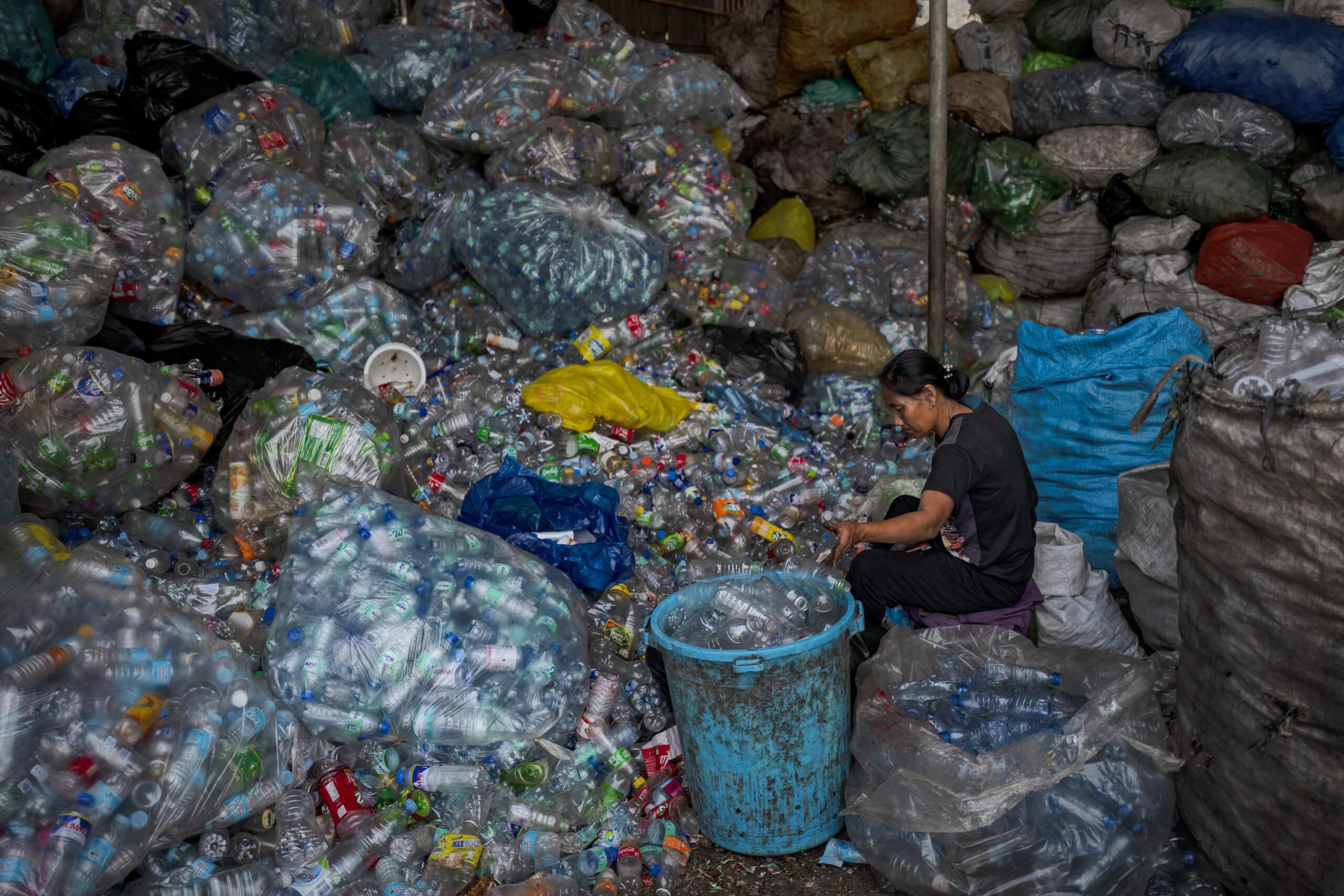 A worker sorts plastic bottles for recycling at a junkshop on April 11, 2023 in Quezon city, Metro Manila, Philippines. (Ezra Acayan/Getty Images)