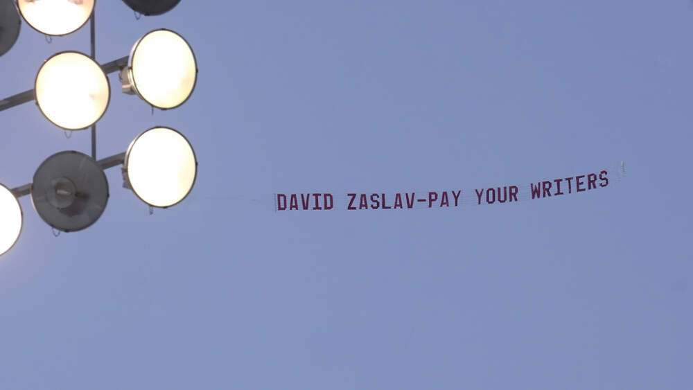 A message in support of the Hollywood writers' strike is pulled by an airplane above Boston University commencement. (Steven Senne/AP)