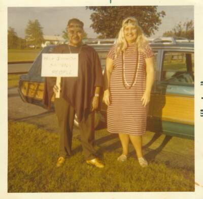 The author’s parents, circa 1970, en route to a costume party, in front of the “Conestoga Wagon.” Their sign says, “Help Stamp Out Skinny People.” (Courtesy Nancy Crochiere)