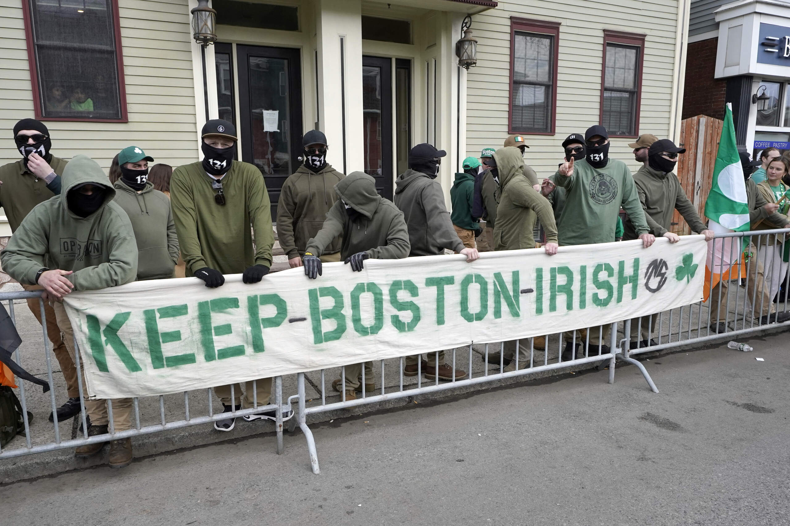 A masked group display a banner with the words "Keep Boston Irish," along the route of the St. Patrick's Day parade on March 20, 2022. (Steven Senne/AP)