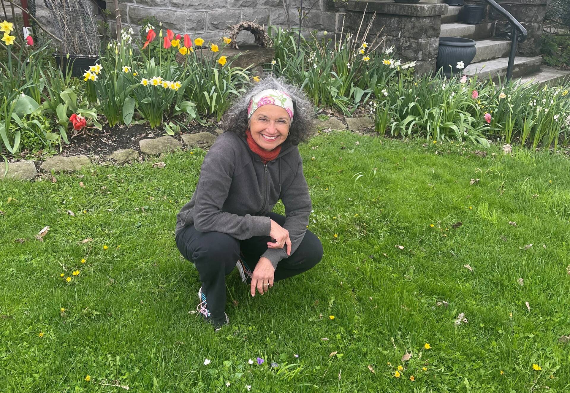 Karima Bondi poses in her yard at the beginning of No Mow May. (Courtesy of Karima Bondi)