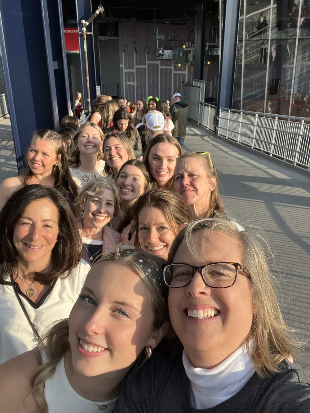 The author, second row center, and the Taylor Swift crew in the "merch" line at Gillette Stadium on May 19, 2023. (Courtesy Joanna Weiss)