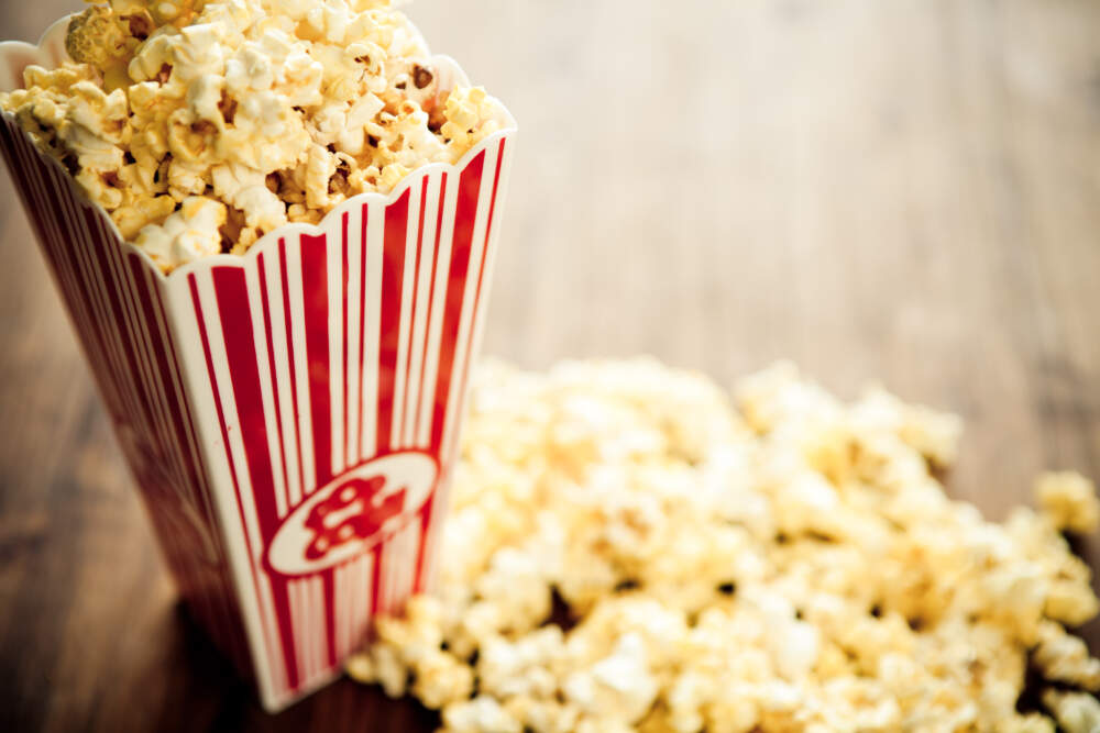 Of course, local film fests and movie theater experiences can often be improved with some buttery popcorn. (MmeEmil via Getty Images)