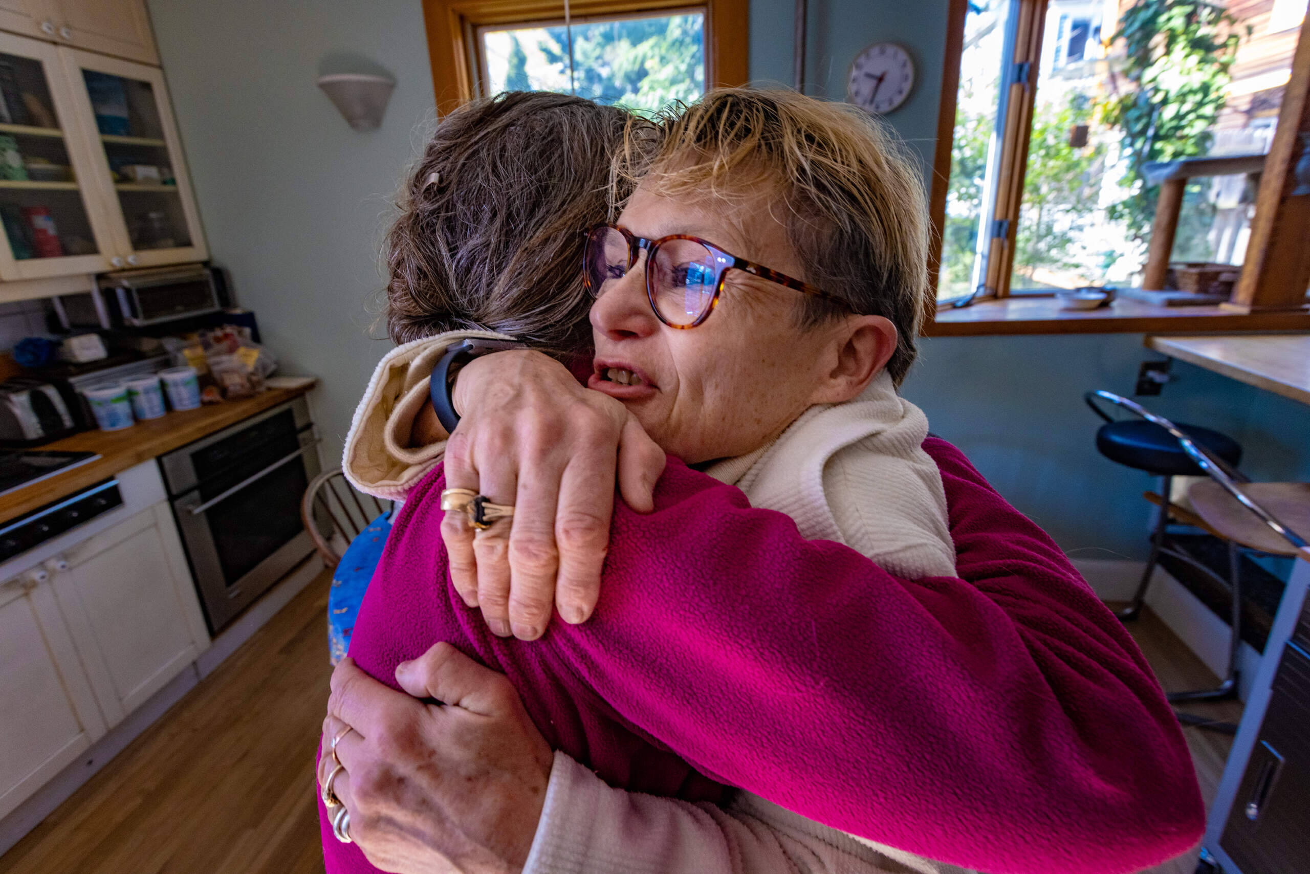 An elated Diane Pullen thanks Dawn Drevers for completing the sweater. (Jesse Costa/WBUR)