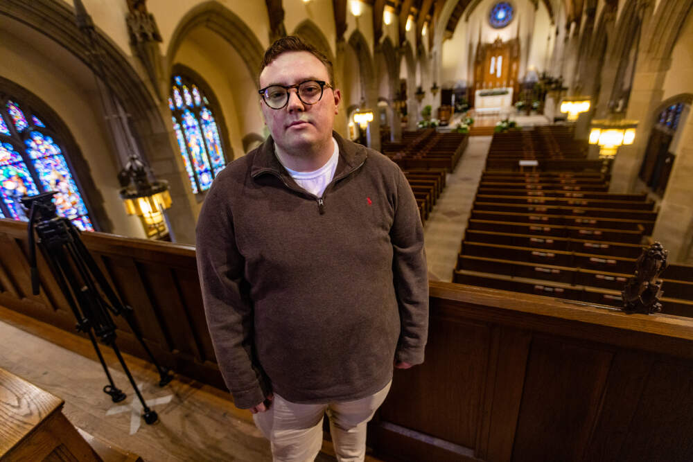 Michael Sennett stands in the balcony of The Jesuit Parish of Saint Ignatius of Loyola in Chestnut Hill. (Jesse Costa/WBUR)