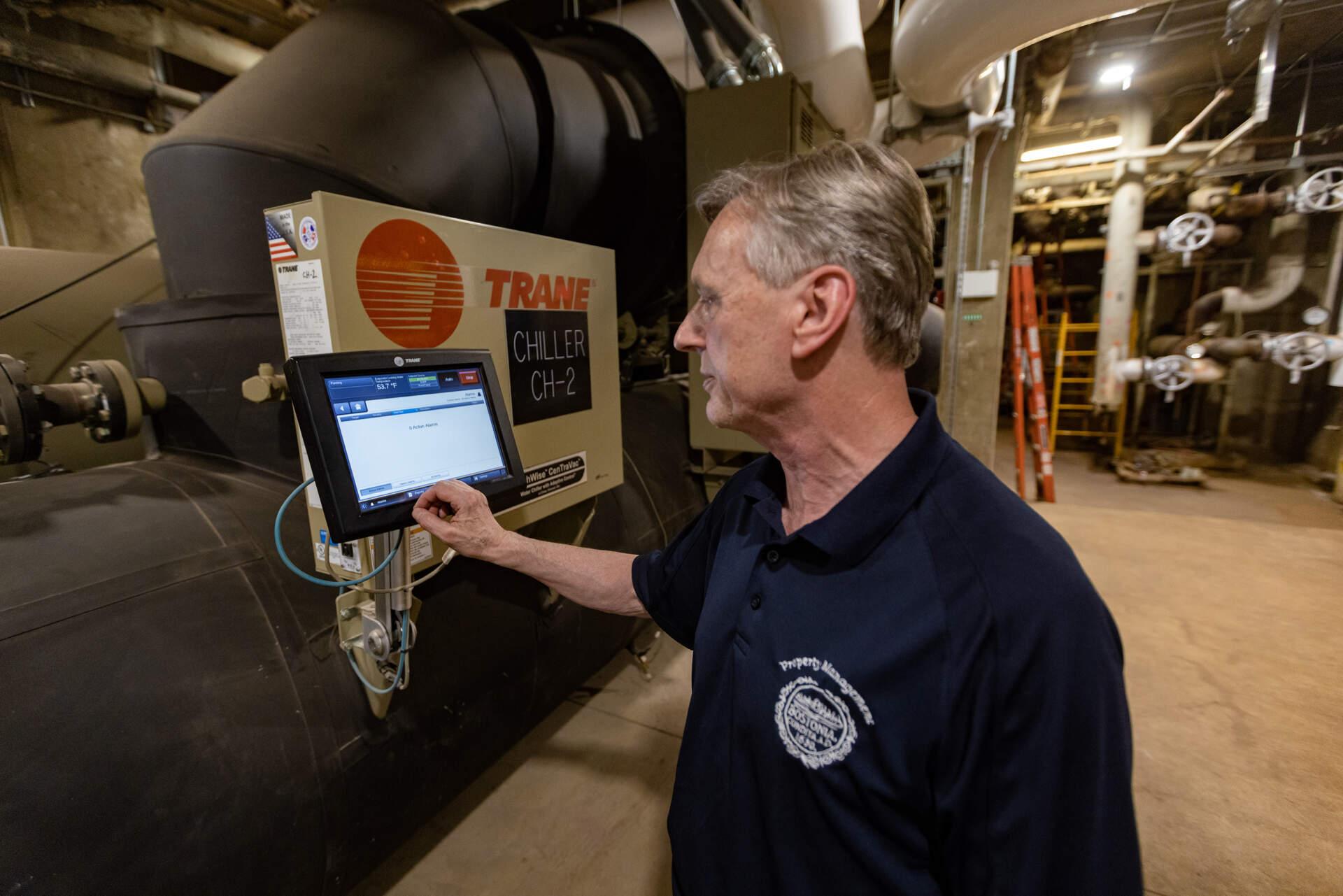 Walter Paluchowski checks one of the chillers in the basement of Boston City Hall. (Jesse Costa/WBUR)