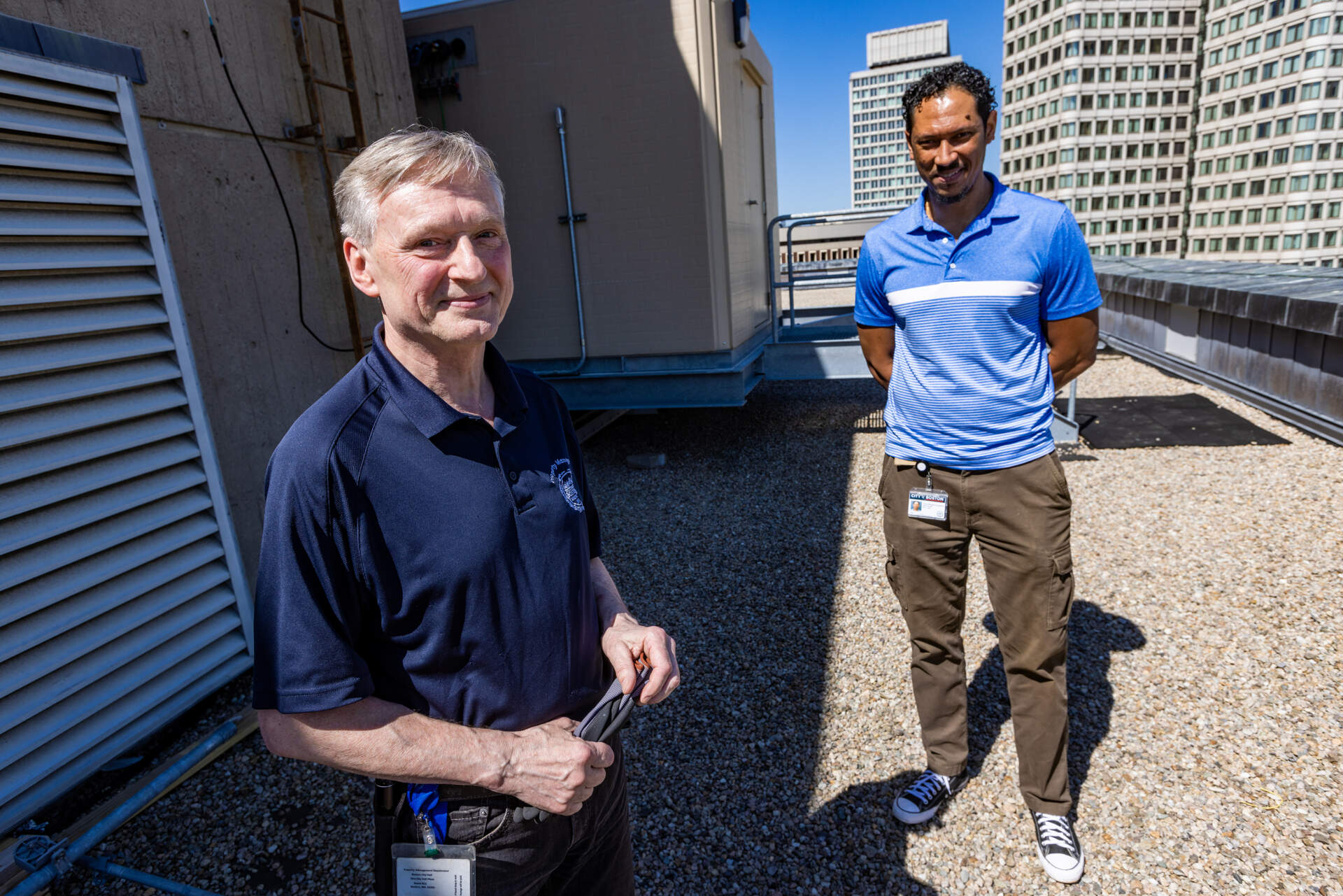 Boston City Hall operations workers Walter Paluchowski and Jose Louro on the roof of Boston City Hall. (Jesse Costa/WBUR)