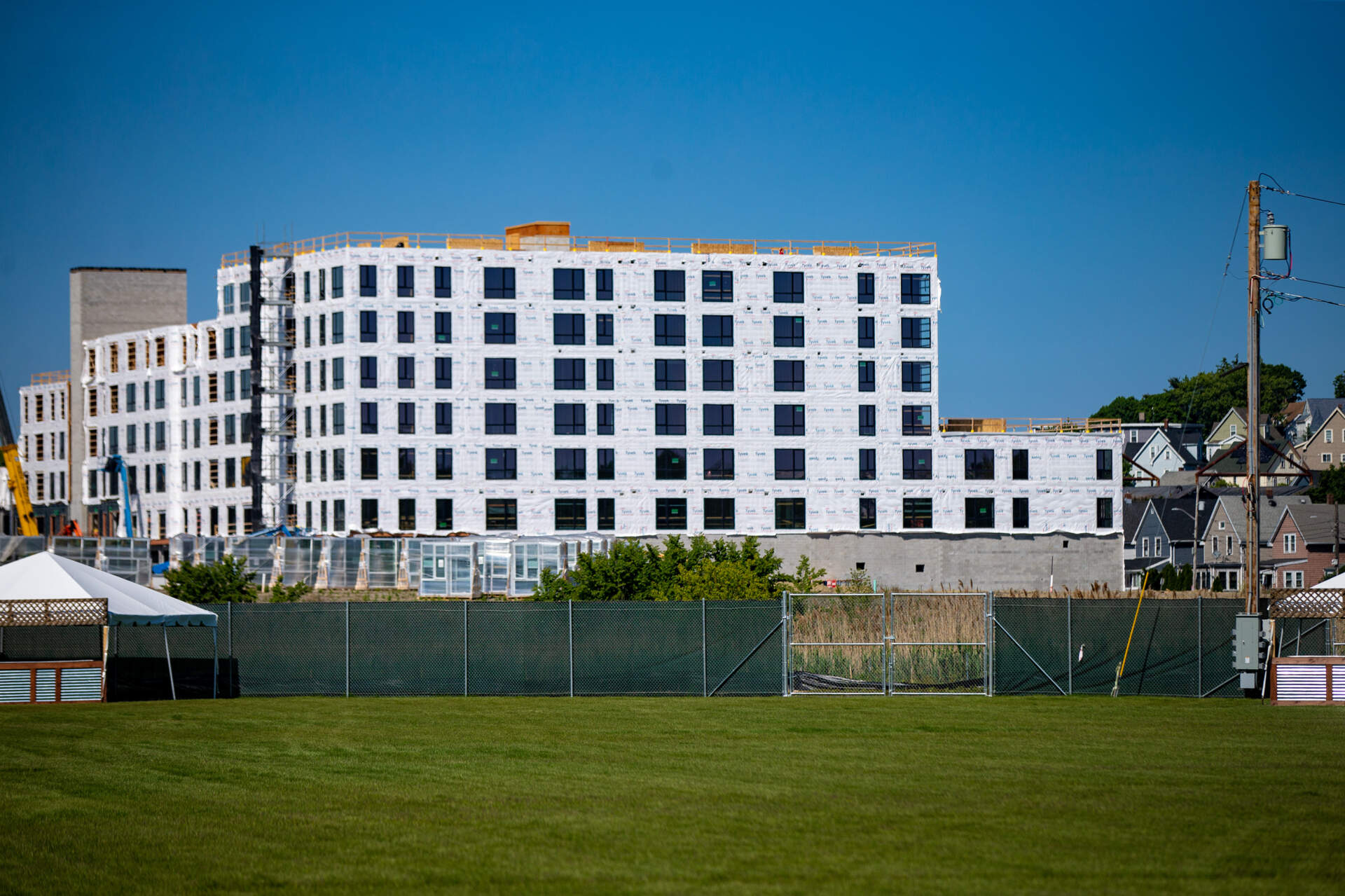 The first residential building of the Suffolk Downs development to be built, Amaya, under construction along Winthrop Avenue in Revere. (Jesse Costa/WBUR)