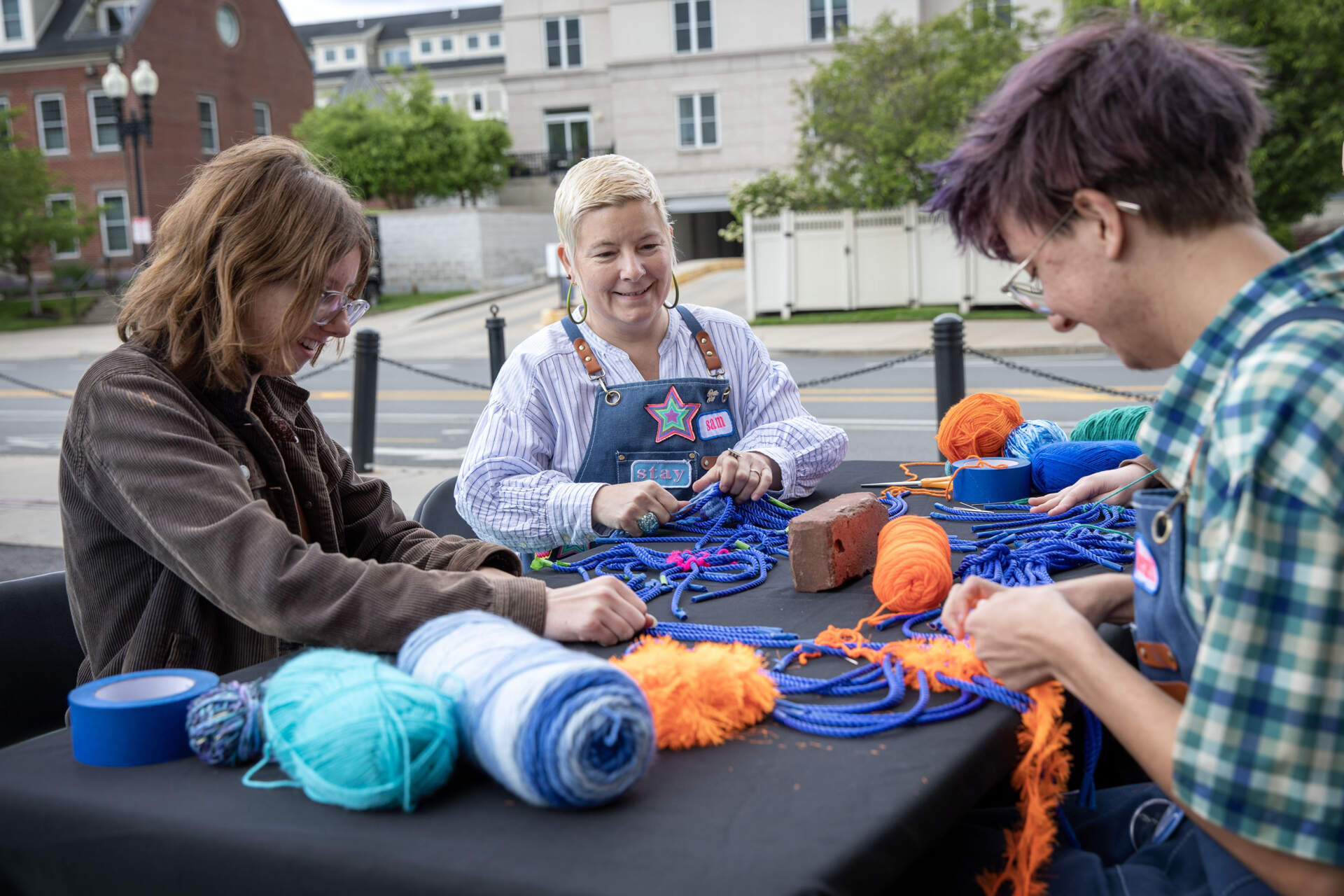 Artist Samantha Fields demonstrates the process of splicing nautical rope at Lot Lab near the Charlestown Navy Yard. (Robin Lubbock/WBUR)