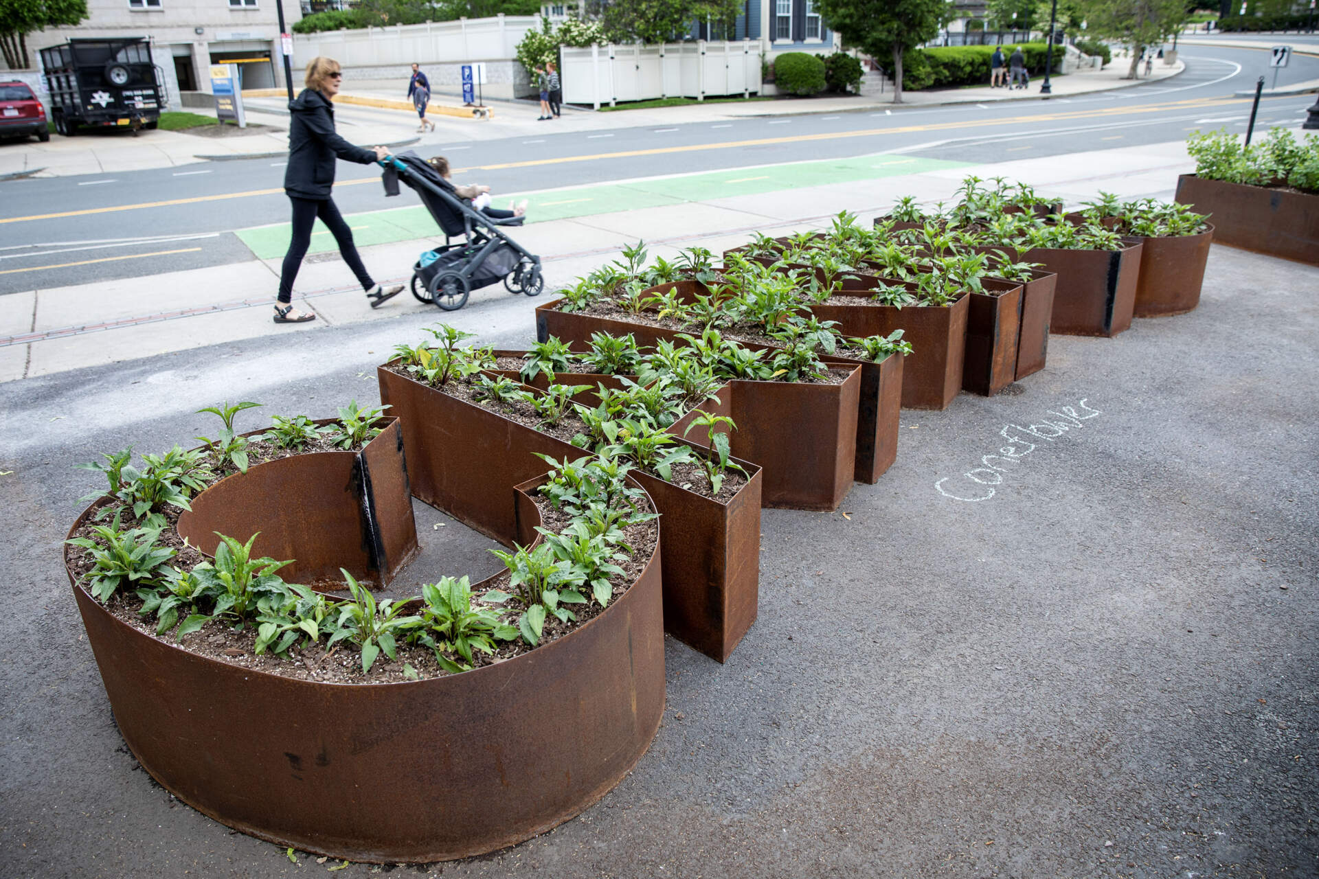 At Lot Lab in Charlestown, one of the circle of raised flower beds in artist Ghada Amer's “Women’s Qualities” spells out the word &quot;caring.&quot; (Robin Lubbock/WBUR)