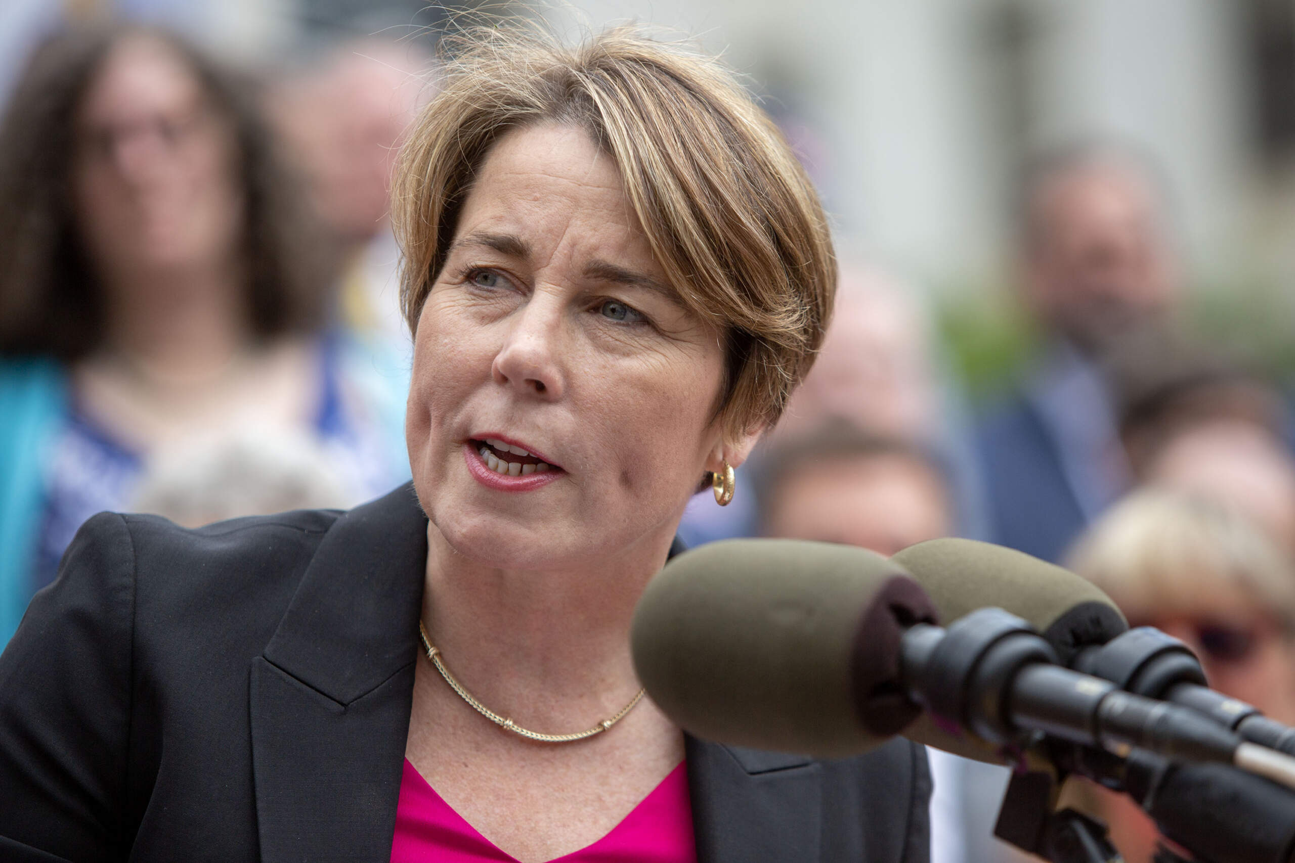 Gov. Maura Healey speaks to people gathered in front of the Massachusetts State House. (Robin Lubbock/WBUR)