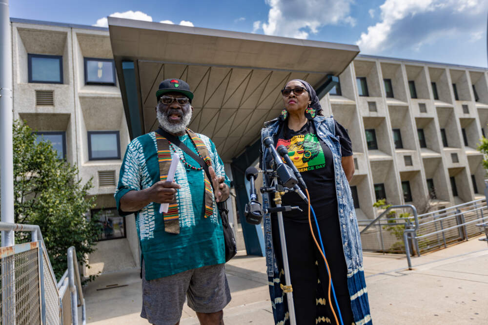 Sadiki Kambon and Priscilla Flint oppose the school’s proposed move to West Roxbury. They also claim the proposal was made without any community consideration or input. (Jesse Costa/WBUR)