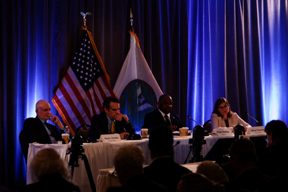 From left, Commissioner Mark C. Christie, Commissioner James Danly, Chairman Willie L. Phillips, and Commissioner Allison Clements of the Federal Energy Regulatory Commission listen on Tuesday, June 20, 2023, at the 2023 New England Winter Gas-Electric forum in Portland, Maine. (Miriam Wasser/WBUR)