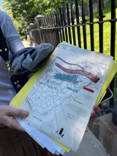 Johanna Hynes, president of Charlestown Historic Battlefield District Committee, holds a map of the Battle of Bunker Hill. (Rupa Shenoy/WBUR)
