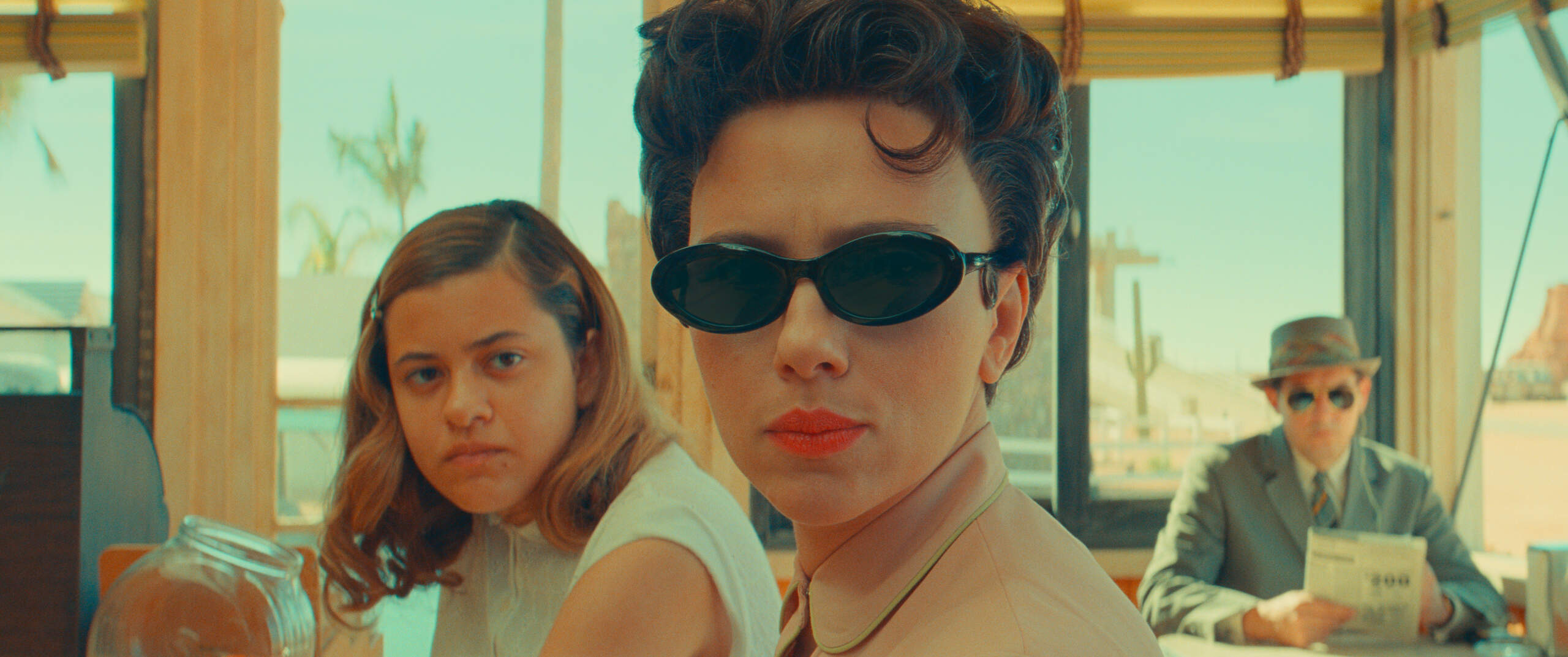 Left to right, Grace Edwards as Dinah, Scarlett Johansson as Midge Campbell and Damien Bonnaro as "Bodyguard/Driver" in writer-director Wes Anderson's "Asteroid City." (Courtesy of Pop. 87 Productions/Focus Features)