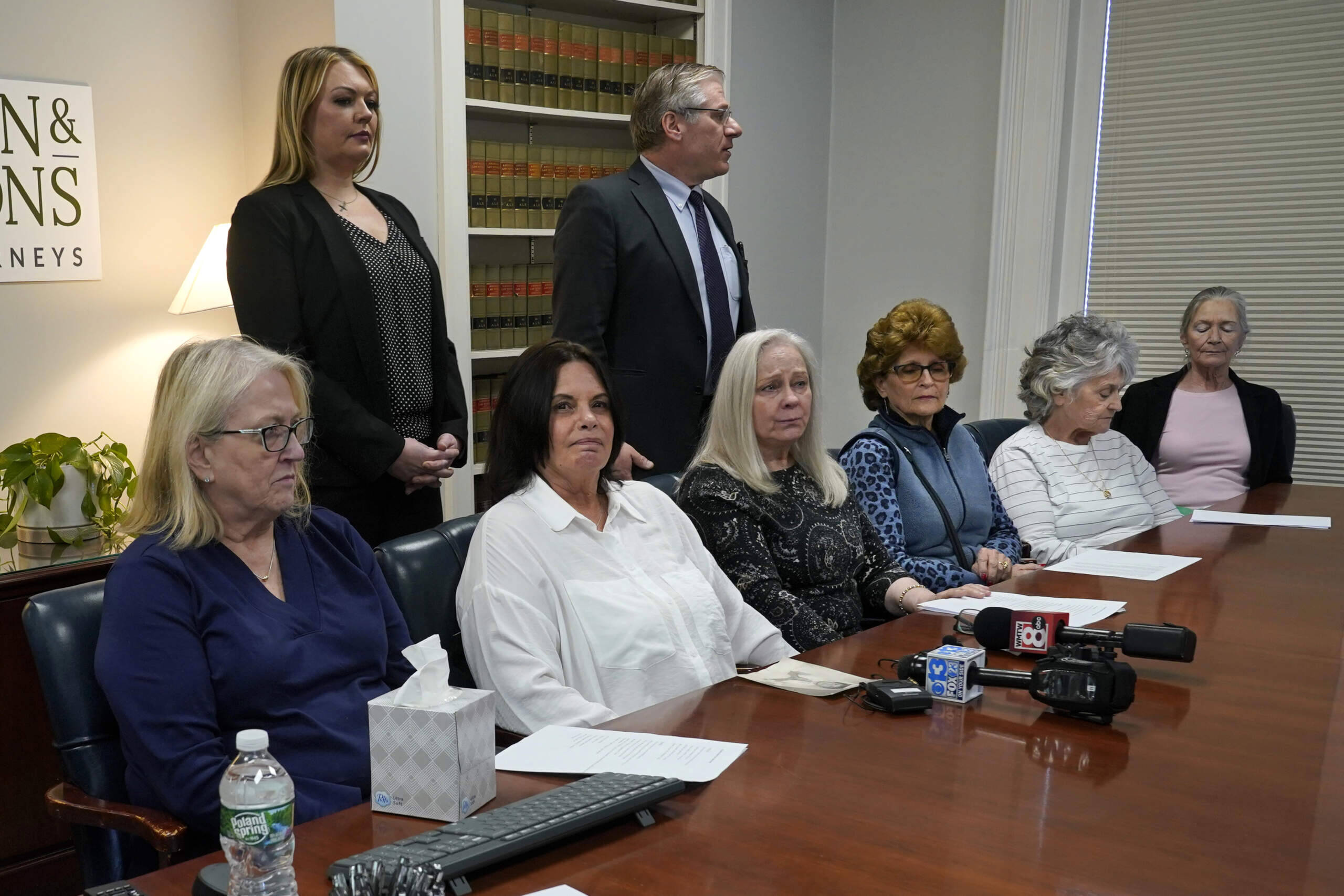 Several women seated next to Ann Allen, second from left, attend a news conference to announce they are joining Allen's lawsuit against the Roman Catholic Diocese of Portland, Wednesday, March 8, 2023, in Portland, Maine. (Robert F. Bukaty/AP)