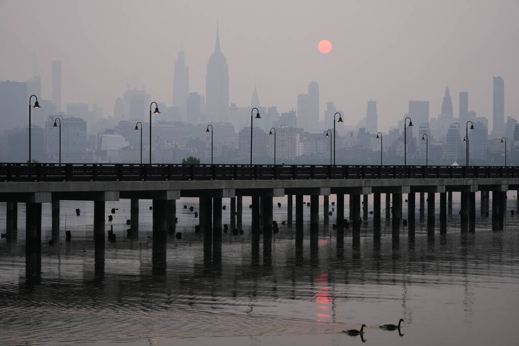 The sun rises over a hazy New York City skyline as seen from Jersey City, N.J., Wednesday, June 7, 2023. (Seth Wenig/AP)