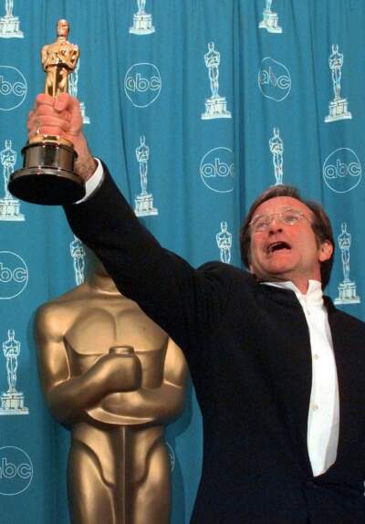 Robin Williams holds his Oscar high backstage at the 70th Academy Awards after won Best Supporting Actor for &quot;Good Will Hunting&quot; in 1998. (Reed Saxon/AP)