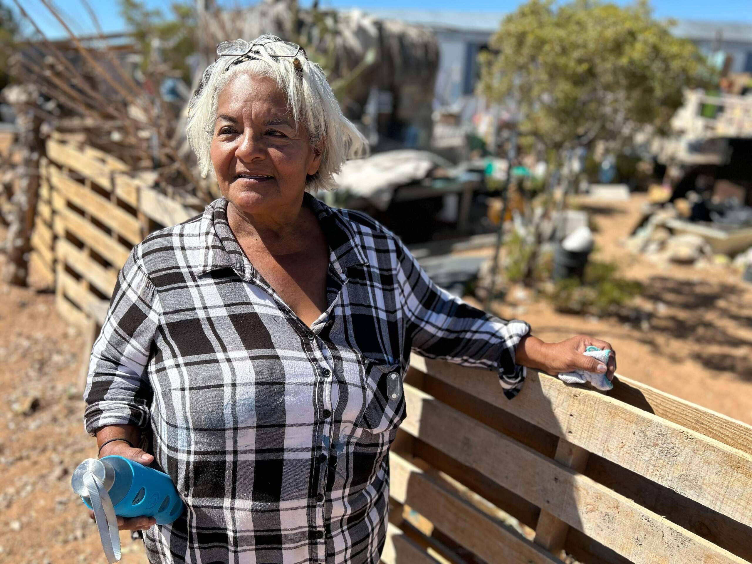 Olga Thomas outside her home in Hueco Tanks, Texas, where residents must haul water from town for drinking, cooking and bathing. (Peter O'Dowd/Here & Now)