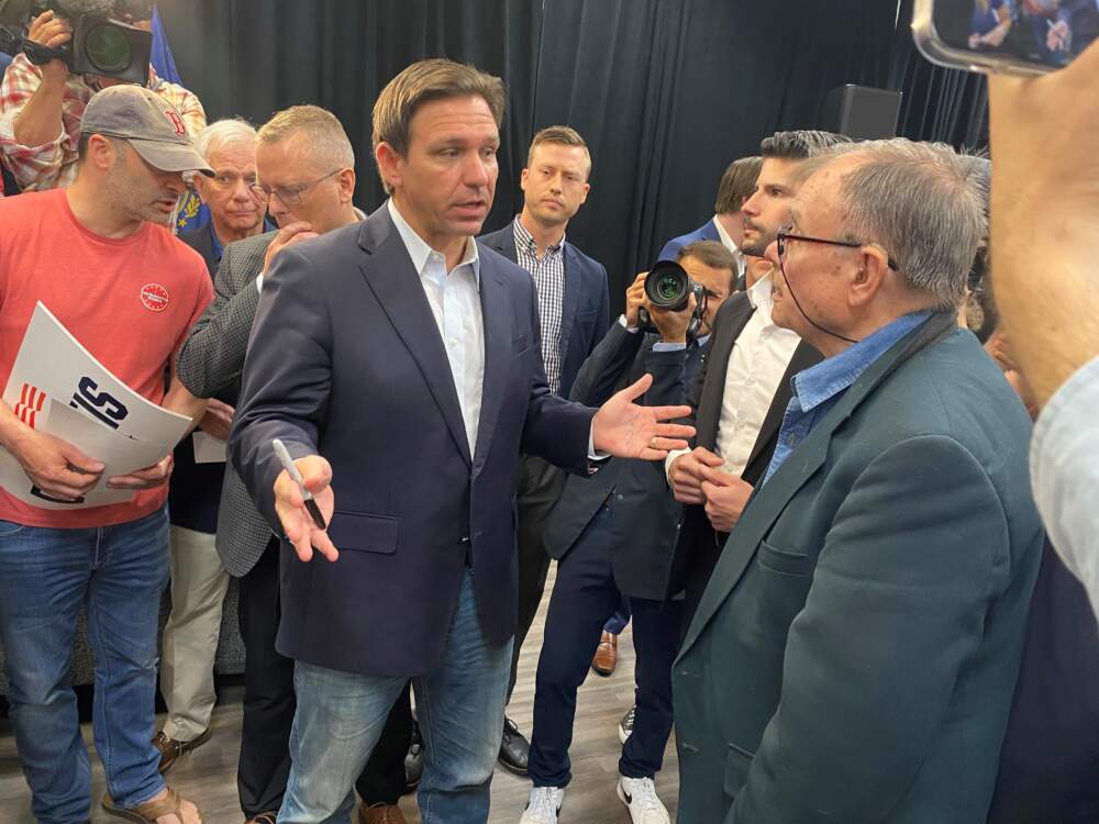 Ron DeSantis talks with voters in Rochester, N.H. on Thursday. (Anthony Brooks/WBUR)