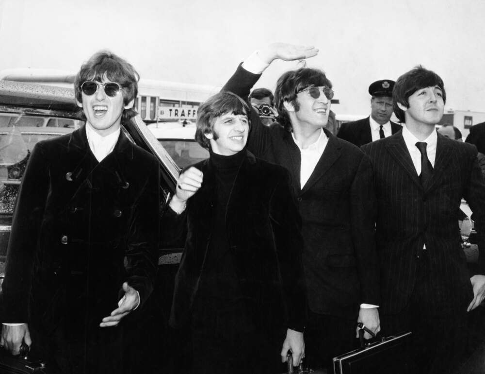 The Beatles, waving to screaming fans en route to Boston, from left to right, George Harrison, Ringo Starr, John Lennon and Paul McCartney, on August 12, 1966. (Daily Express/Archive Photos/Getty Images)