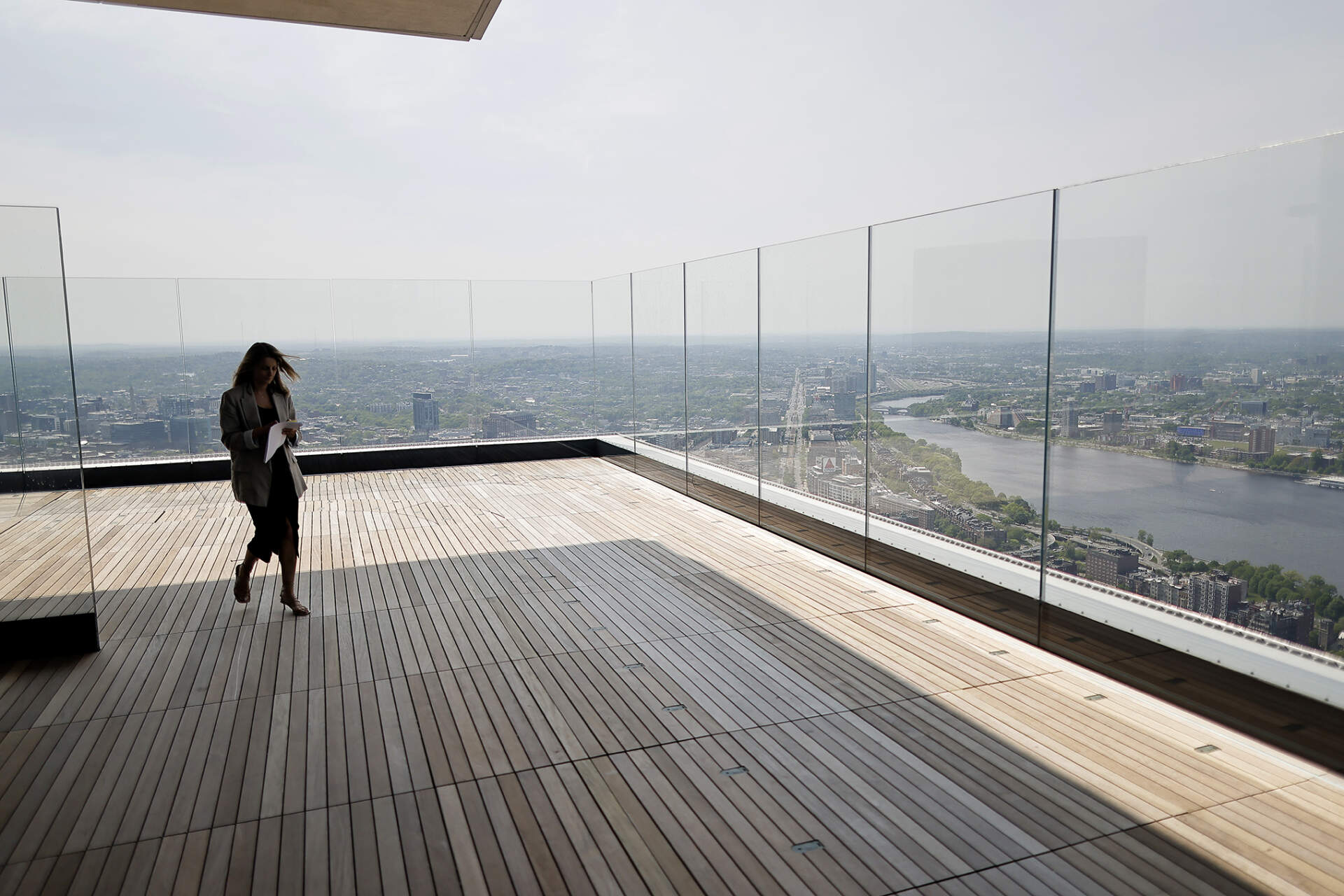 Rebecca Stoddard, the vice president of marketing at BXP, walks out on the deck of "The Cloud Terrace", an outdoor wraparound deck on the 51st floor. (Photo by Lane Turner/The Boston Globe via Getty Images)