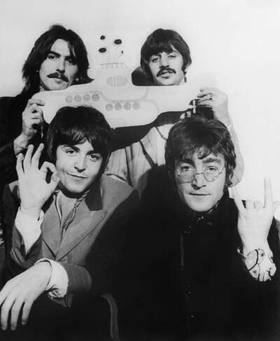 The Beatles hold a submarine during their announcement to make the animated film Yellow Submarine later released in 1968. From left to right: George Harrison (top left), Ringo Starr (top right), John Lennon (bottom right), and Paul McCartney (bottom right).