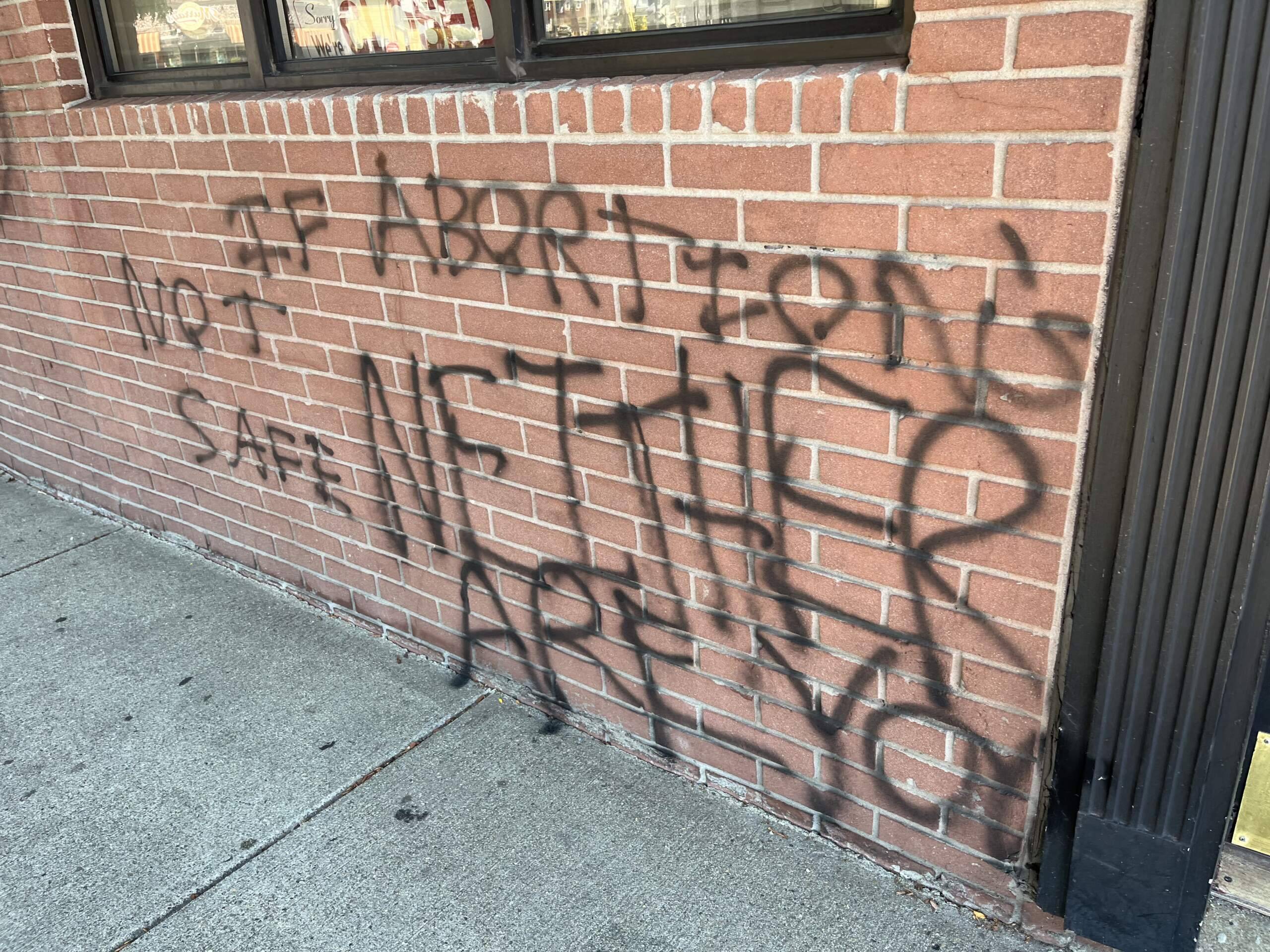 A threat on the building of Your Options Medical in Revere, spraypainted last summer. (Courtesy Teresa Larkin)