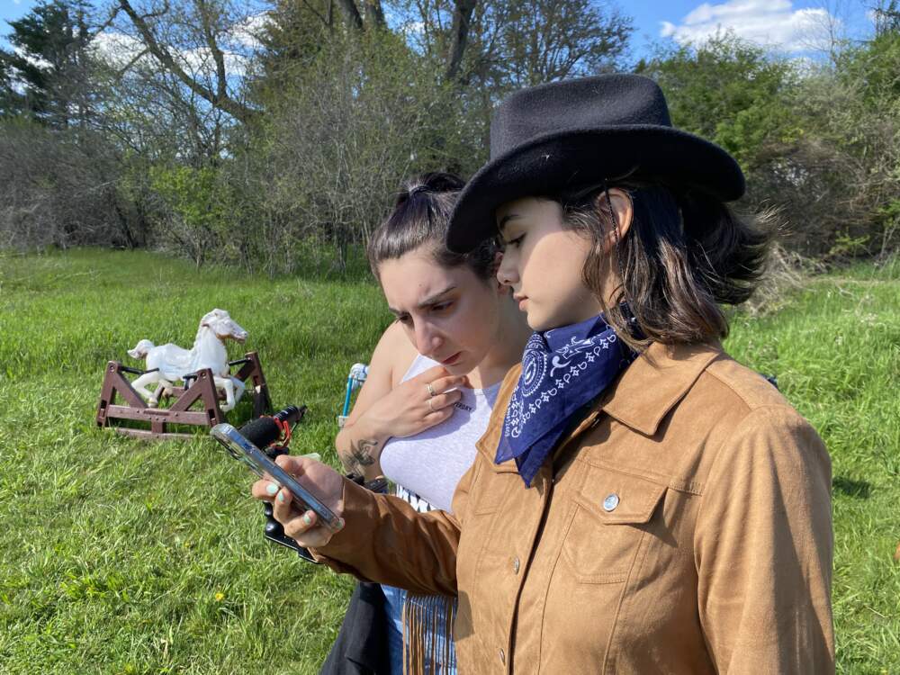 Julie Curiale and actor Madison Cayer go over lines of dialogue before shooting a pivotal scene at Ponyhenge. (Andrea Shea/WBUR)