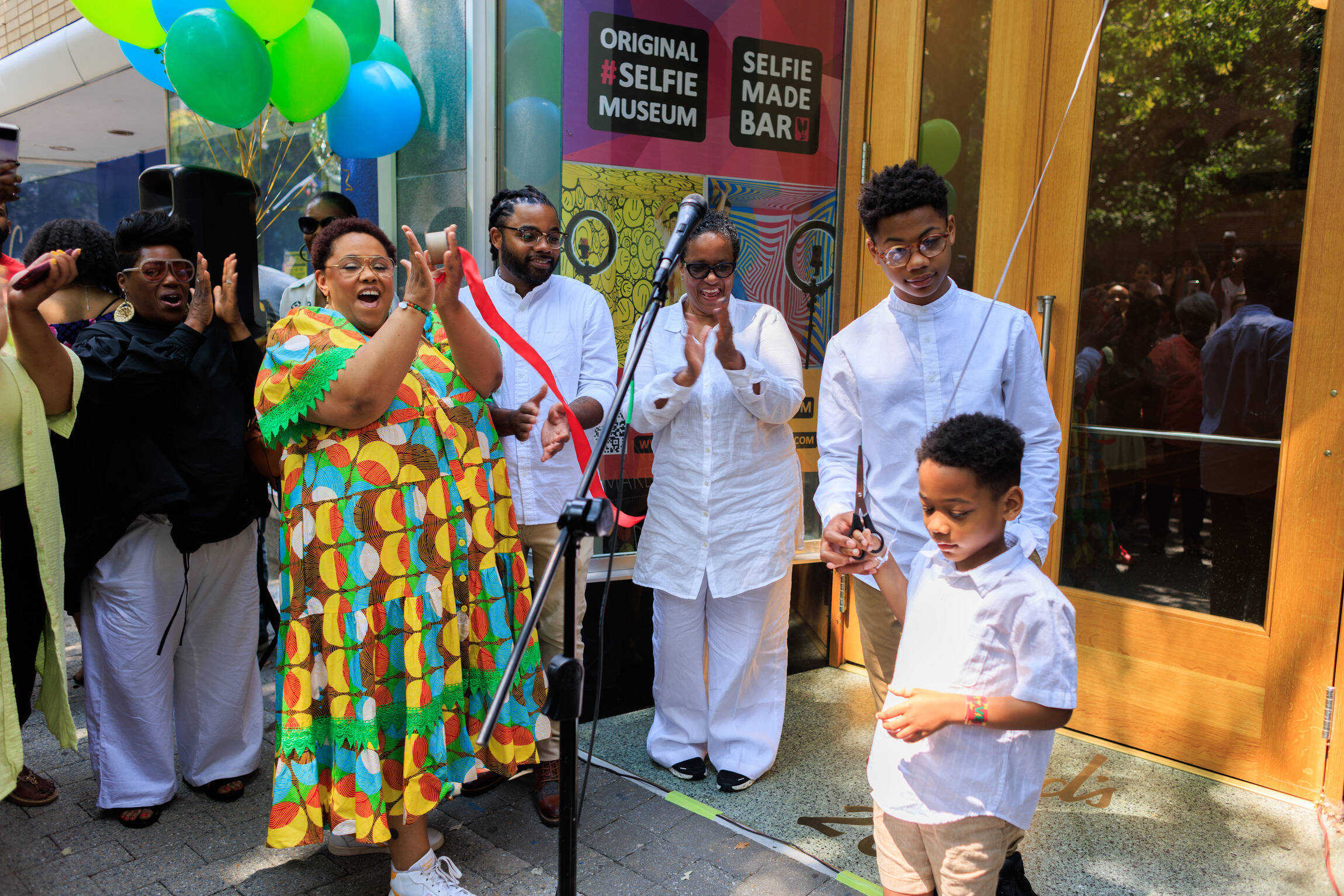 Owner Victoria Scott-Miller and her son, Emerson, cut the ribbon at the grand opening of her Liberation Station Bookstore.North Carolina’s first Black-owned children’s bookstore opened June 17, 2023 in downtown Raleigh. (Phillip Loken)