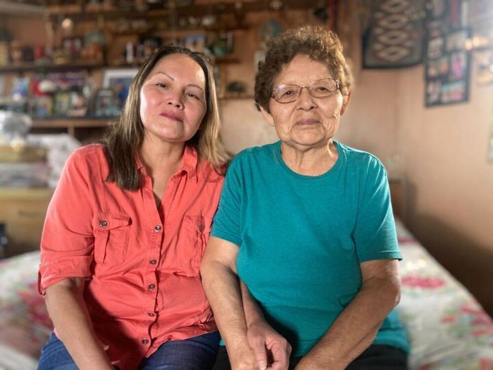 Sheila Emmons, left, and her mother Abbie Nez inside a hogan on the Navajo Nation. Nez has lived in the home for decades with running water or electricity. (Peter O'Dowd/Here & Now)