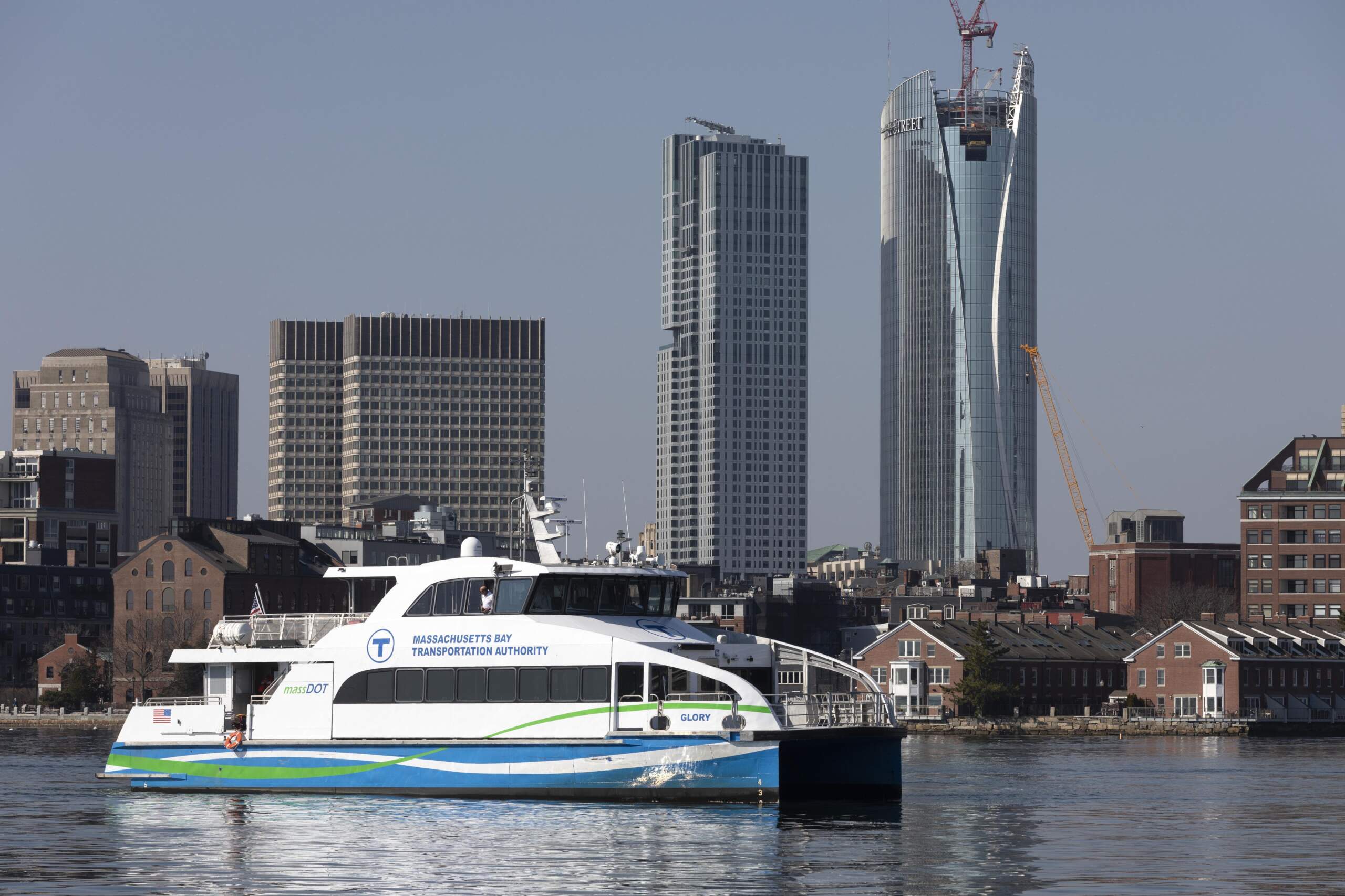 An MBTA passenger ferry floats through Boston Harbor. (Michael Dwyer/AP Photo)