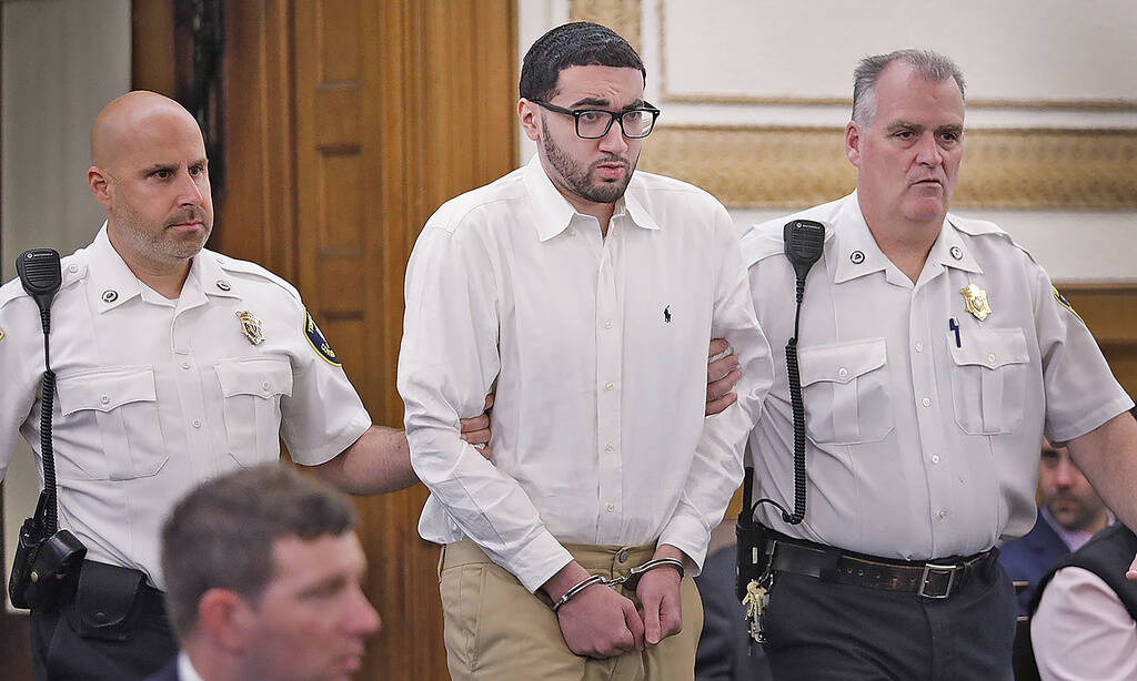 Emanuel "Manny " Lopes is escorted into Norfolk Superior Court in Dedham on June 8, 2023, for the first day of his trial for the 2018 murder of Weymouth Police Sgt. Michael Chesna and Vera Adams. (Greg Derr/The Patriot Ledger via AP, Pool)