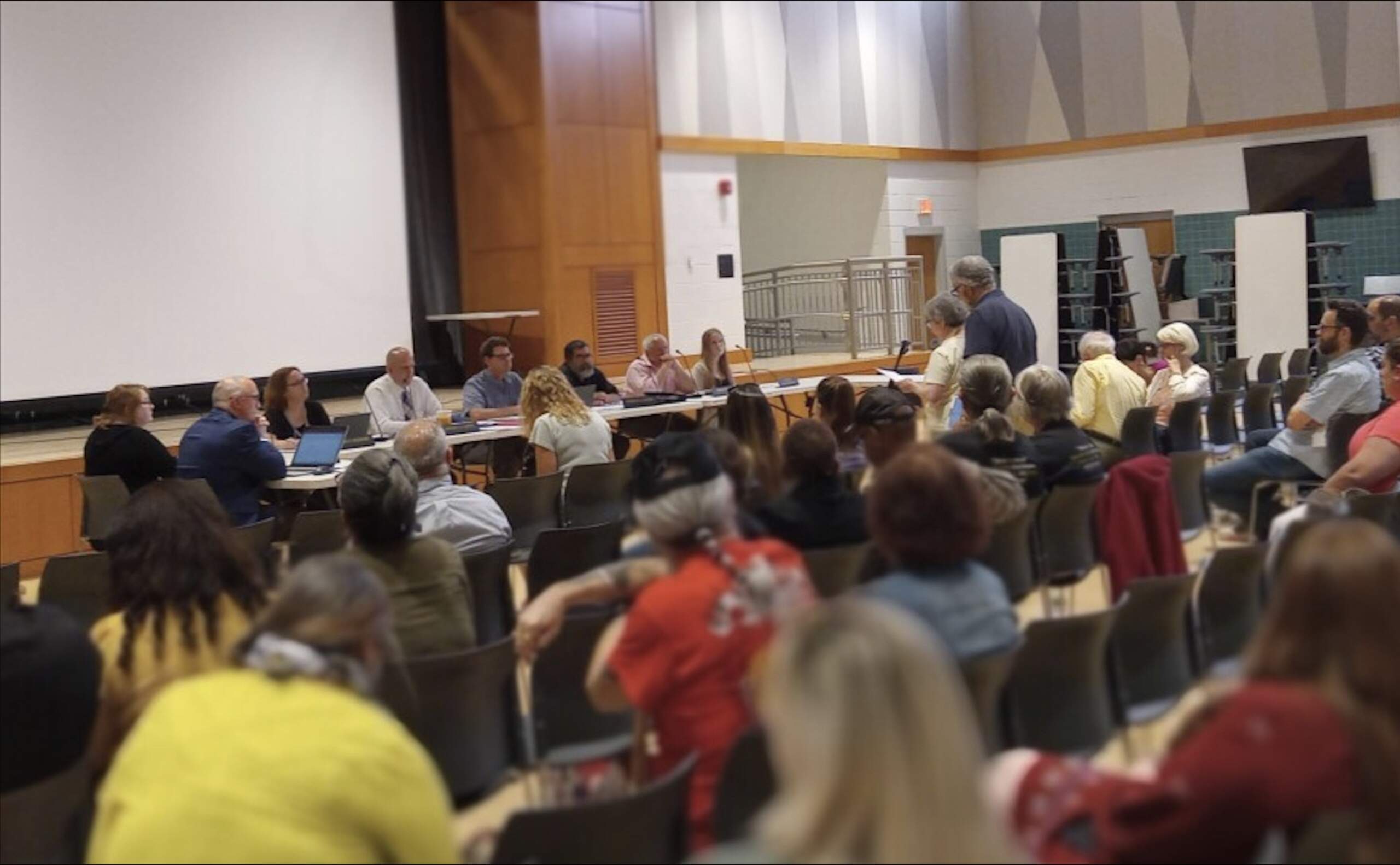 A divided crowd showed up at the Ludlow School Committee meeting, June 13, 2023. The committee declined to vote on a controversial library materials proposal, leaving the current policy in place. (Jill Kaufman/ NEPM)