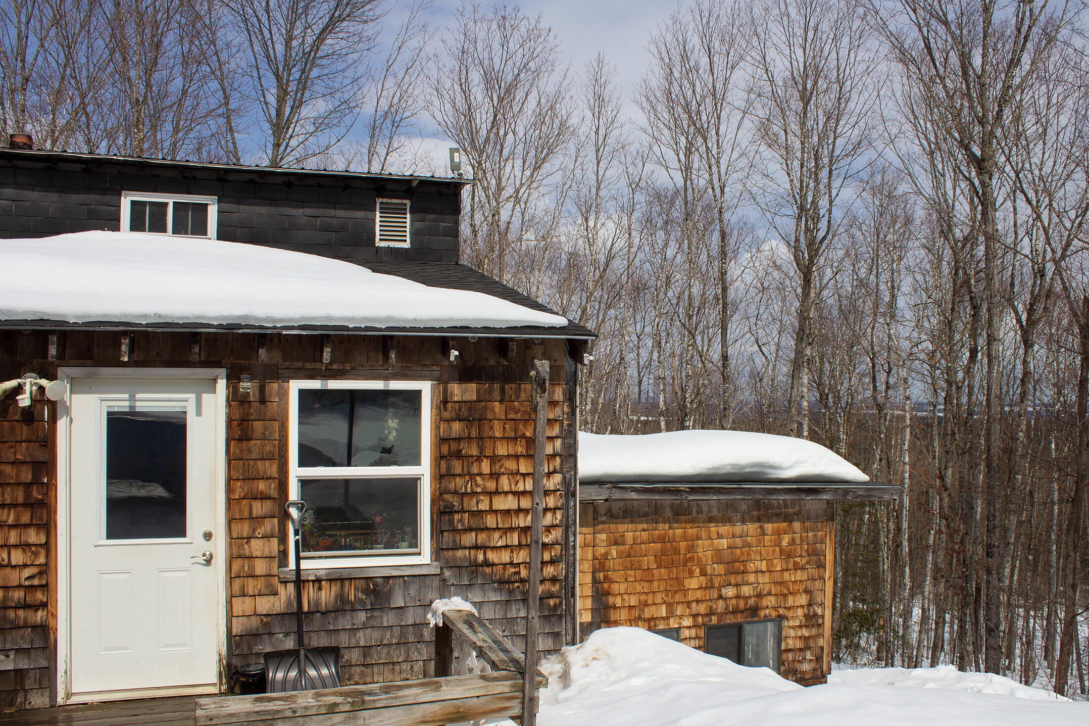 Bob Moody’s house in Castle Hill, Maine, is heated with oil, like many rural, older Maine homes. He built it with scrap from a former air base, and there are insulation challenges to heating the home efficiently. (Annie Ropeik for The Maine Monitor)