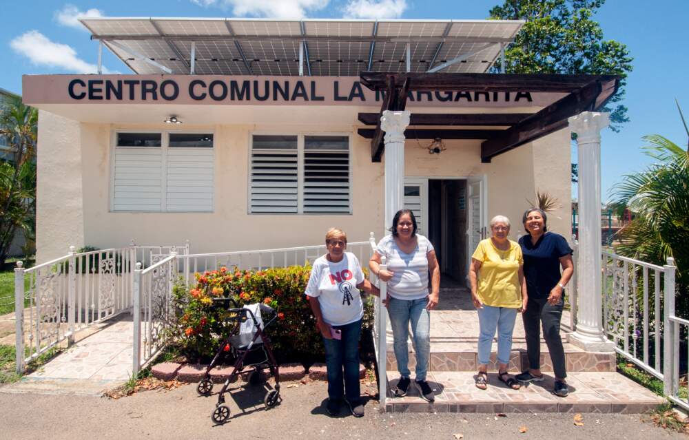 Wanda Ríos, second from left, is president of The Asociación de Residentes de la Margarita (ARLM) in Salinas, Puerto Rico. The community organization formed in response to flooding in their neighborhood and is working to install solar panels on their homes (Chris Bentley/Here & Now)