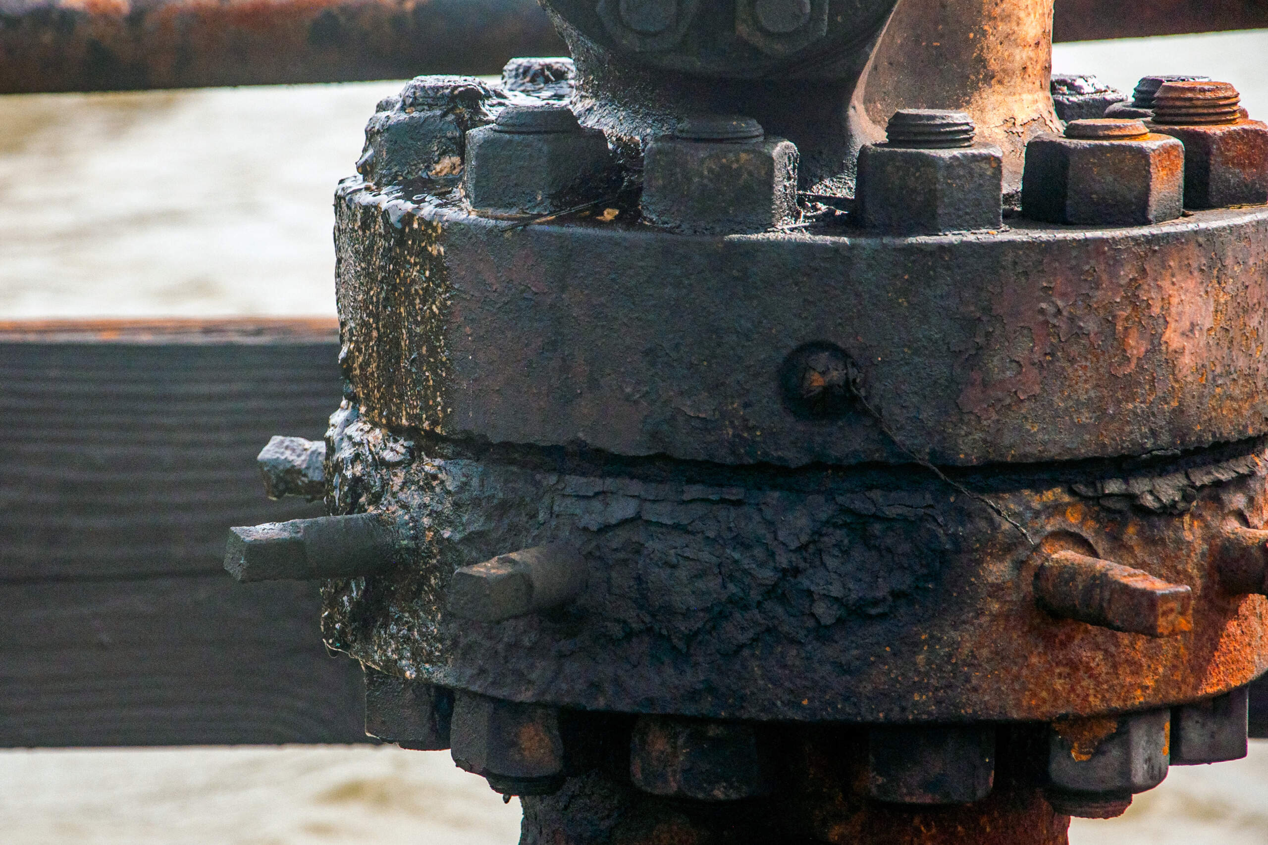 An abandoned well in Plaquemines Parish, Louisiana leaks dark fluid. (Chris Bentley/Here & Now)