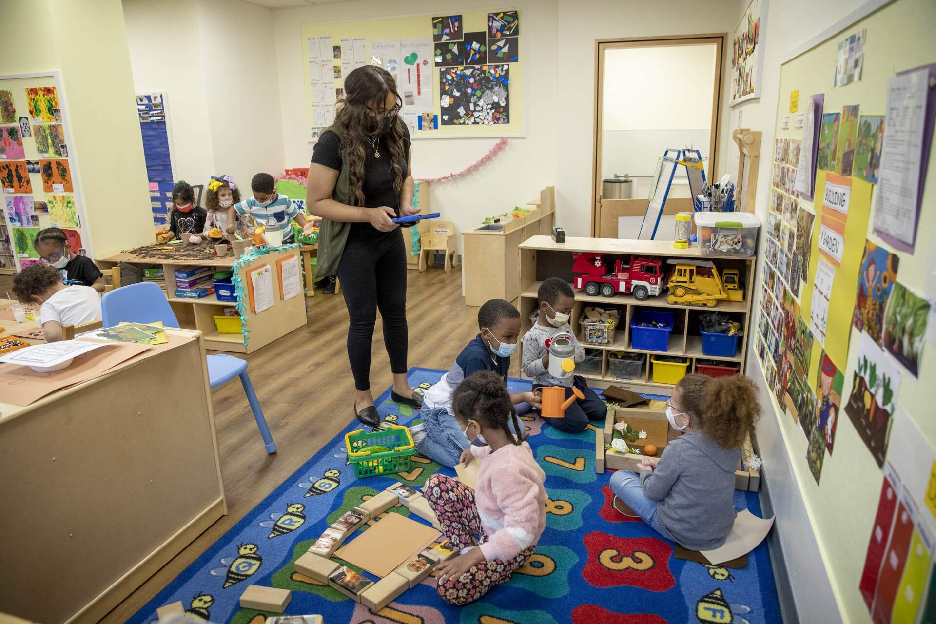 Teacher Kiya Savannah works with children at the Ellis Early Learning Center in Boston. (Robin Lubbock/WBUR)