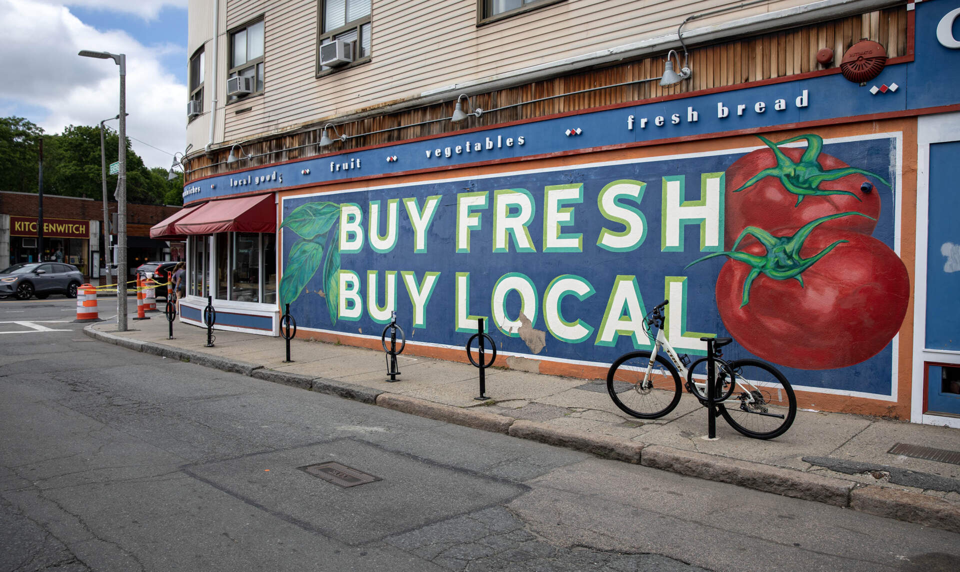 A mural on one side of City Feed and Supply in Jamaica Plain encourages people to 
